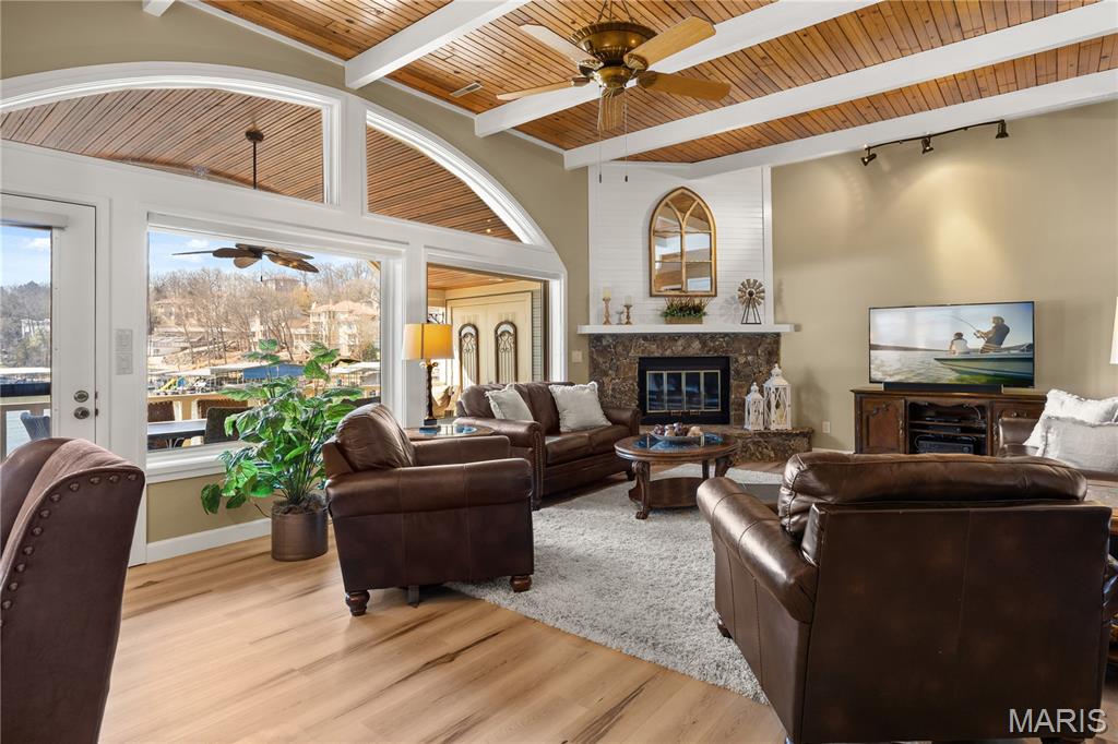 Experience tranquil lakeside living in this luxurious 3BR/3BA villa at the 25MM. Nestled in a protected NO-WAKE cove, this residence is part of the exclusive Lake Point community--a gated, 20-unit non-rental enclave surrounded by 30 acres of wooded privacy. Boasting top-quality finishes from a 2025 remodel, the home features engineered hardwood, updated staircases, and LVP. The spacious living room shines with tongue-and-groove beamed ceilings, a stone fireplace, and new Andersen lakeside windows with plantation shutters. The gourmet kitchen highlights sleek granite countertops, KitchenAid appliances, and a wet bar with a commercial-grade icemaker. Retreat to the upper-level primary suite with heated bathroom floors. This unit includes a large covered deck, attic fan, and extra storage. Boaters will love the two massive slips (expandable to 14x54 and 18x54) plus a double PWC lift. Enjoy resort amenities like a pool, tennis, and pickleball courts, all while being minutes from dining and shopping. This is a rare, low-traffic sanctuary where every detail has been perfected. Experience the best of lake life in a one-of-a-kind setting! This masterpiece is ready for its new owner!