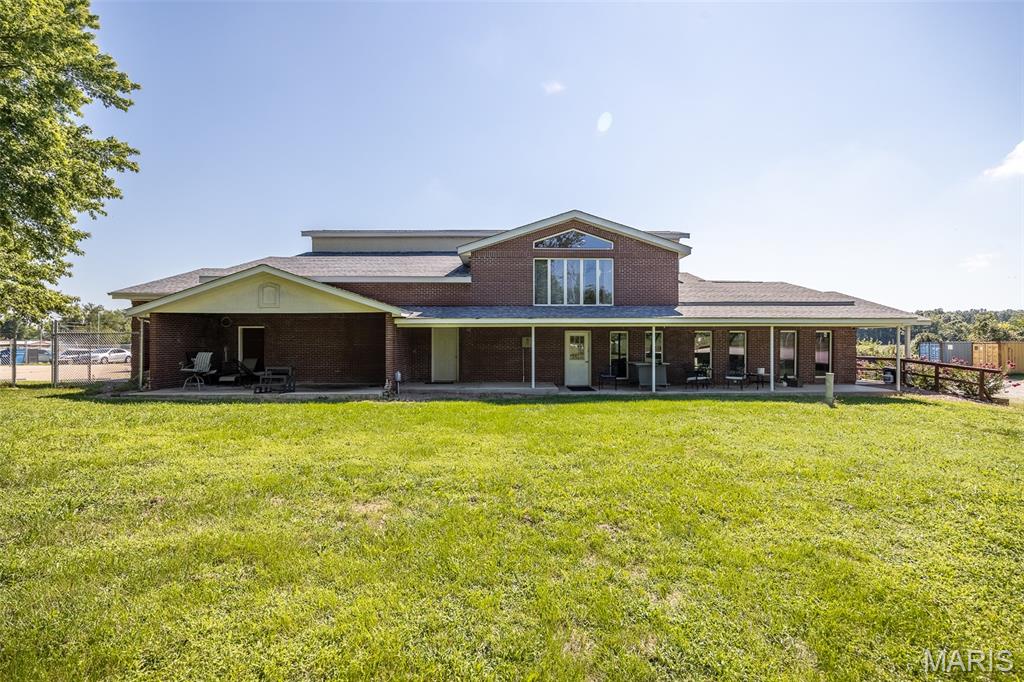 If you're searching for the ultimate live-work property, this one is truly in a class of its own! Situated on 1.89 acres with a fenced parking area and gated access, this incredible property features a massive all-in-one building offering approximately 5,000 square feet of warehouse space, a 4,312 square foot office complex, and a spacious 2,409 square foot apartment upstairs. The lower level is filled with expansive meeting and gathering areas, multiple kitchen spaces, private offices, and numerous multi-purpose rooms that can be adapted to fit virtually any business or personal need. Whether you're looking to operate a growing company, establish a corporate headquarters, create a training or event facility, or develop a unique mixed-use space, the possibilities are endless. Upstairs, the well-appointed apartment provides comfortable onsite living for owners, employees, or guests, making this a true all-in-one property. With a rare combination of warehouse, office, and residential space under one roof, this property offers flexibility that is hard to find. This is a property that must be seen in person to fully appreciate its size, layout, and endless potential. The opportunities are limited only by your imagination!