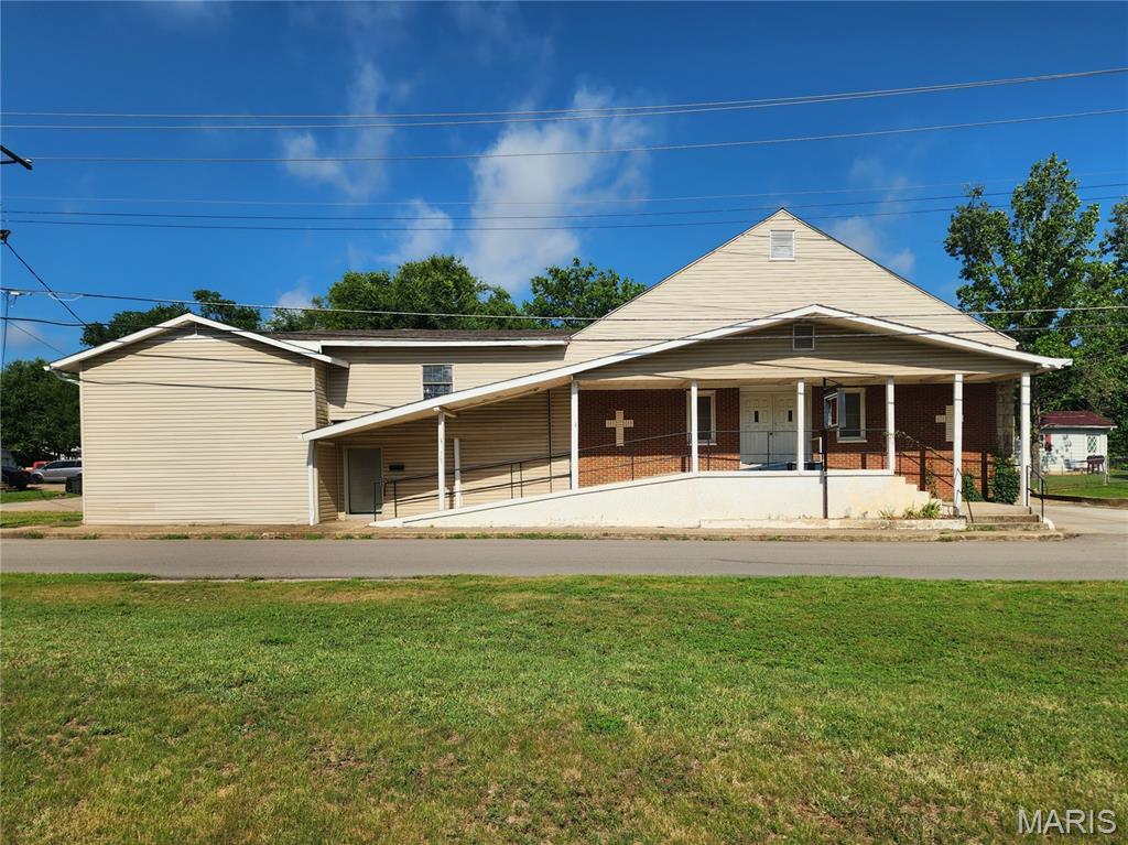 Versatile mixed-use property with exceptional potential! This former church building is zoned C-2, allowing for a variety of possible uses, including residential, multi-family, commercial, or continued religious use. Offering over 6,000 square feet above grade, nearly 1,000 square feet of basement storage, and situated on two surveyed parcels totaling 0.27 acres, this property provides a flexible layout for a wide range of opportunities.
The exterior features four separate entrances, making it well-suited for multiple occupants or divided-use configurations. Additional exterior features include a parking lot with alley access, frontage on two city streets, and a driveway along the rear of the property.
The approximately 2,500-square-foot sanctuary includes two restrooms, a small office, and a nursery. The adjoining upper and lower levels offer approximately 3,700 square feet with seven classrooms, a large recreation room, an additional restroom, and a two-bedroom apartment/parish complete with a full kitchen and bathroom.
Property is being sold in it's current condition and church furnishings will be included with the sale. The entire roof was replaced in 2022. The building is serviced by two electric meters — sanctuary and two-story section.
Whether you're looking to continue its current use or explore redevelopment, the property's zoning and layout offer flexibility for uses such as professional offices, educational or daycare facilities, an event venue, residential conversion, or multi-family investment, subject to local approvals.
301 S. Division Street, Bonne Terre — $99,900. Schedule your private tour today!