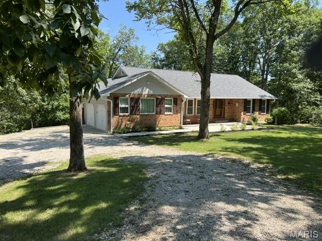 Secluded, well-maintained ranch home sits on 3.82 acres at the end of the street. This property is for nature lovers seeking privacy and serenity.

Family room is nicely sized with a wood-burning fireplace opening to dining area and kitchen. Home has 3 split bedrooms & 2 full baths. Laundry room off kitchen. Appliances stay. All new windows & sliding door (2023).  

Unfinished walk-out basement has newer sump-pump/drain tile system with transferrable warranty (2020), water heater &  water softener (2024) & Amana Hi-Efficiency HVAC/digital thermostat (2024). 

Has newer roof (2020) & newer gutters/downspouts with leaf guard system (2021). Front sidewalk/patio poured (2023). Large back deck recently painted & is wired for sound system. 14x24 outbuilding with electric has 2 overhead storage areas. 

This home offers privacy & nature & only 10 min from town. Enjoy peaceful mornings, serene evenings & the beauty of a wooded paradise. You won’t want to miss this one!