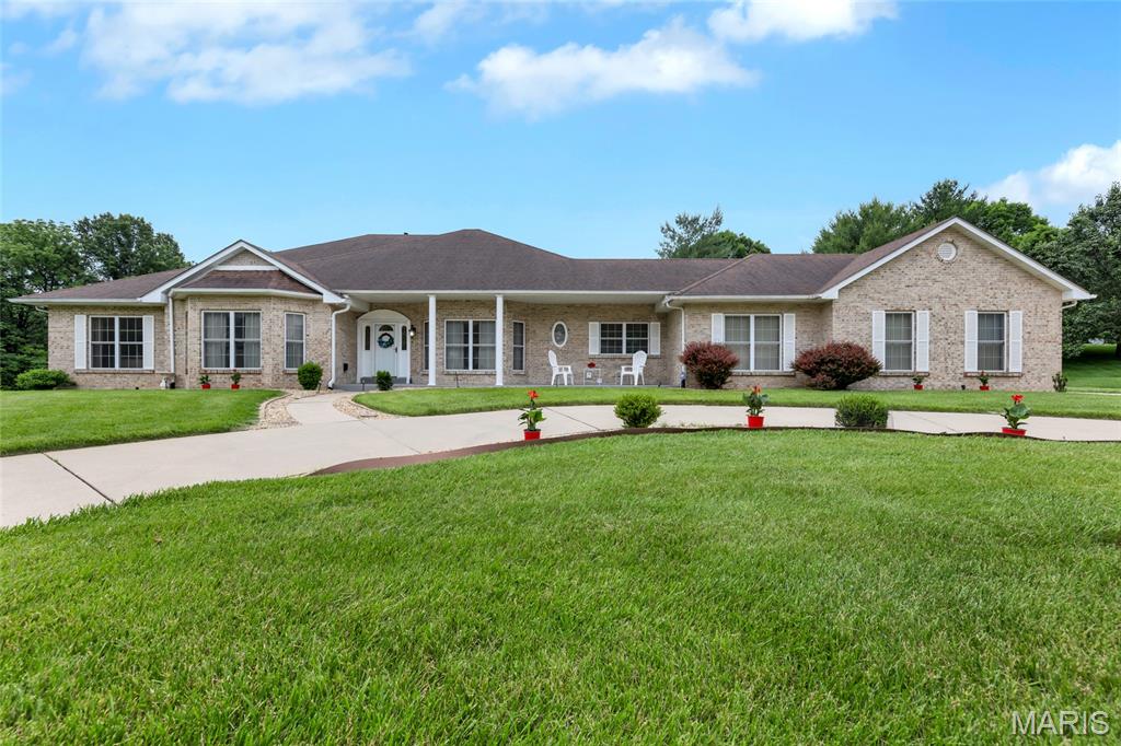 BOM No Fault of Seller. Nestled in a gem cul de sac, 17971 Argonne Estates Drive is an exceptional custom ranch offering over 5,100 square feet of refined living space, thoughtfully designed with 4 bedrooms, 6 bathrooms, and a total of 12 well-appointed rooms that blend luxury, comfort, and functionality. From the moment you enter the expansive foyer, you are welcomed by soaring 11-foot ceilings, rich hardwood flooring, elegant crown molding, and an abundance of natural light streaming through striking bay windows and floor-to-ceiling glass in the impressive family room, complete with a gas log fireplace and new window blinds. The chef’s kitchen is both expansive and highly functional, featuring granite countertops, a generous breakfast bar, two pantries, custom cabinetry with thoughtful details such as dual lazy Susans, and a bright breakfast room framed by a charming bay window; appliances conveying including freezers and two refrigerators. The main level also offers a formal dining room and private office—both enhanced with bay windows—along with a well-equipped laundry room featuring cabinetry, counters, and a utility sink. The expansive primary suite provides a true retreat with vaulted ceilings, a luxurious en-suite bath, and an oversized walk-in closet, while all main-level bedrooms include their own walk-in closets, offering comfort and privacy for family and guests alike. Outdoor living is elevated by a newer composite deck with integrated solar lighting, perfect for relaxing or entertaining. Car enthusiasts and hobbyists will appreciate the rare five-car heated, drywalled, and finished garage, along with the added peace of mind of a whole-home generator. The finished walk-out lower level features a 9-foot pour and extends the home’s versatility with a large great room anchored by a second gas fireplace, a kitchenette, an additional bedroom plus a sleeping area—both with new carpeting, premium padding, walk-in closets, and full baths with ceiling heat lamps—creating an ideal space for guests, multigenerational living, or extended stays, all opening to a private terrace. This remarkable home combines thoughtful design, generous scale, and premium amenities in a highly desirable setting, offering a rare opportunity to experience elevated ranch-style living at its finest. No pet/ No smoking zone.