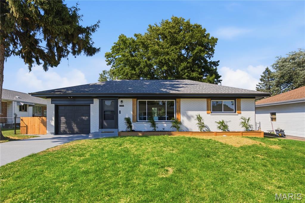 Beautifully redone from top to bottom, this move-in ready 2-bedroom, 1-bathroom home offers the perfect combination of modern updates, functional living space, and major system improvements. The striking exterior features a freshly painted brick façade, attractive landscaping, mature shade trees, and exceptional curb appeal that immediately sets this home apart. Step inside to find a bright, open-concept floor plan filled with natural light, luxury flooring, neutral colors, and stylish finishes throughout. The spacious living room flows seamlessly into the dining area and beautifully updated kitchen, featuring modern cabinetry, stainless steel appliances, ample counter space, and a layout designed for both everyday living and entertaining.

Both bedrooms are generously sized with large windows and ample closet space, while the updated bathroom showcases contemporary fixtures and finishes. The attached one-car garage provides convenient parking and additional storage, while the expansive lower level offers excellent potential for a recreation room, workout area, or future finished living space. Outside, you'll love the freshly poured concrete patio overlooking the large, level backyard—perfect for summer barbecues, entertaining guests, or simply relaxing outdoors. Thoughtful landscaping and well-maintained grounds create an inviting outdoor setting with plenty of room to enjoy.

In addition to the cosmetic renovations, this home offers valuable peace of mind with a new AC condenser, updated electrical system, and an updated sewer lateral. Combining quality craftsmanship, modern style, major mechanical updates, and a fantastic layout, this beautifully renovated home is ready for its next owner to move right in and enjoy.