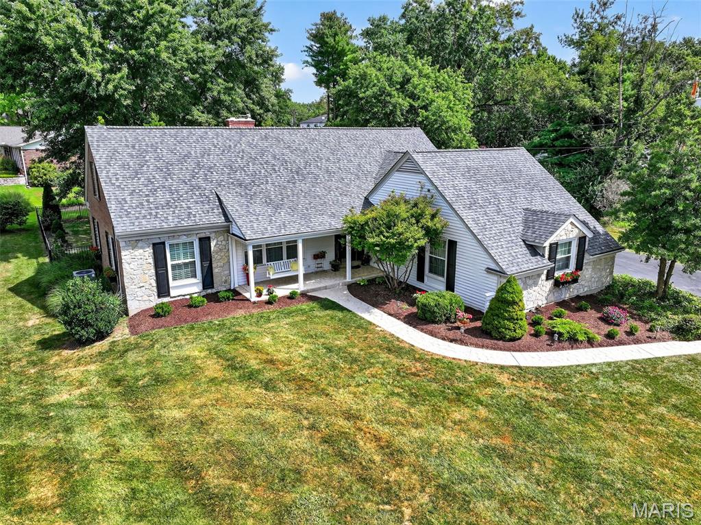 Welcome to this beautifully appointed 1.5-story predominantly brick/stone residence nestled on a meticulously maintained lot in one of Des Peres' most prestigious neighborhoods. Boasting 5 spacious bedrooms and 3 full baths, this home offers the perfect blend of timeless elegance and modern comfort.  Step inside to find rich hardwood flooring complemented by fresh paint throughout, creating a bright and inviting atmosphere. The textured carpeting in the bedrooms adds a warm, luxurious touch, while large windows flood the space with natural light. The open and functional layout provides ideal spaces for both everyday living and entertaining. Living Room, Formal Dining Room, Family Room and Sunporch offer an array of living options. 2-main floor bedrms (one used as an office) & 3 large bedrms on 2nd floor offer plenty of space. Chef's kitchen with breakfast area, 42" cabinetry, granite counters, gas cooktop, double oven stove, frig, microwave & dishwasher plus large main floor laundry with stackable washer/dryer is ideal for most homeowners.  Several access points in/out from main level to gorgeous, private, large lot loaded with trees. A side-entry garage enhances curb appeal and convenience, and the manicured grounds offer the perfect setting for outdoor enjoyment. Unfinished LL offers plenty of storage space. Don’t miss this rare opportunity to own a move-in-ready gem in one of the most sought-after communities in Des Peres—where prestige, location, and style come together.