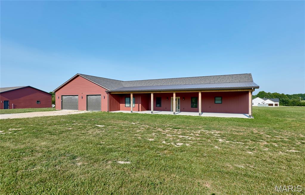 PRICED BELOW a recent $848,000 appraisal (completed Feb. 2026, BEFORE the third building was finished), this extraordinary property offers incredible value. MOTIVATED SELLERS are relocating, creating a RARE OPPORTUNITY for the next owner. Combining quality construction, exceptional versatility, and over 3,000 sq. ft. of finished living space, this ONE-OF-A-KIND property is perfectly suited for multi-generational living, a home-based business, contractor, hobbyist, collector, or anyone looking for room to spread out.

Situated on a beautiful 3.05-acre corner lot with BLACKTOP frontage and MINIMAL RESTRICTIONS, the property features a thoughtfully designed 3-bedroom, 2-bath main home with approximately 1844 sq. ft. of living space. Built with comfort and efficiency in mind, you'll appreciate the 9-foot ceilings, dramatic vaulted great room, luxury vinyl plank flooring throughout the main living areas & plush carpet in the bedrooms. The open-concept kitchen is designed for entertaining with quartz countertops, a large center island, stainless steel appliances, soft-close cabinetry and drawers, pantry, and ample workspace. The adjoining dining and living areas flow seamlessly, making gatherings effortless.

The spacious primary suite offers a relaxing retreat with dual vanities, a custom walk-in shower, and an oversized walk-in closet that was specially engineered with reinforced metal anchors to serve as a STORM-SAFE SHELTER. Additional highlights include a dedicated home office, spacious laundry room and an attached 40'x60' finished garage/shop featuring 10-foot ceilings, a FULL BATHROOM and endless possibilities for recreation, storage, a workshop, fitness area, or business use.

Outdoor living is just as impressive with a welcoming 16'x40' covered front porch, a matching 16'x40' covered back porch (with wall mounted TV), and a 22'x28' concrete patio with gazebo, creating the perfect setting for morning coffee, family gatherings, or evening entertaining while enjoying peaceful country views.

A sidewalk leads to the detached GUEST HOUSE, offering approximately 1,200 sq. ft. of additional finished living space. Complete with 2 bedrooms, a full kitchen, living room, full bath and an approximately 40'x30' finished garage with metal-lined interior, it's ideal for extended family, in-laws, guests, private office space, rental income potential (not on separate meters), or independent living. The refrigerator, stackable washer, and dryer all remain.

The newest addition is an outstanding 40'x70' outbuilding designed to accommodate large equipment, recreational vehicles, trailers, boats, or commercial-style storage. It features 12-foot ceilings, four 10'x10' overhead doors, concrete floors, 220-volt electric, and an expansive 70'x100' parking, making loading, unloading, maneuvering large vehicles, or equipment storage exceptionally convenient. (Please see restrictions attached in supplements)

As an added bonus, approx. 17 wall-mounted TVs throughout the buildings are included, making the property move-in ready for entertaining, business operations, or simply enjoying multiple living and recreation areas.

Conveniently located with easy access to state highways while offering the privacy and freedom of country living, this exceptional property truly offers possibilities that are difficult to find. Whether you're searching for flexible living arrangements, incredible garage space, room for your toys, or the perfect live/work setup, this property is ready to exceed your expectations. Their loss is your gain. Call today for a private showing!