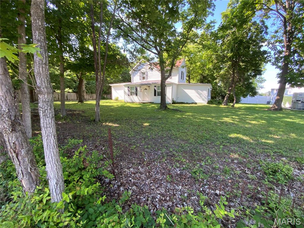 Rare opportunity in the heart of Wildwood's Town Center Historic District! Situated on a beautiful 0.546-acre lot (23,784 sq. ft.) along Old Manchester Road, this charming circa 1880, 1.5-story home offers endless possibilities for homeowners, investors, and business owners alike.

With over 3,249 square feet of living space, this historic property features 9 rooms, 5 bedrooms, 2 full baths, and 1 half bath, including a main-floor primary bedroom, main-floor laundry, and spacious living areas throughout. The inviting living room showcases a decorative fireplace, while the updated kitchen offers granite countertops, stainless undermount sink, GE Profile refrigerator, Whirlpool smooth-top electric range, Whirlpool dishwasher, ceramic tile flooring, and abundant cabinet space. The spacious laundry room includes a washer and dryer and features ceramic tile flooring.

The second floor provides additional bedrooms, a full bath, generous closet space, and ample storage. Mature trees, a stone patio, and a detached garage enhance the property's appeal and create a picturesque setting.

Numerous improvements completed prior to 2014 include 200-amp electrical service, furnace and air conditioning, vinyl siding, replacement windows, and connection to the lateral sewer system.

Currently zoned residential, the property may offer the potential for rezoning to certain commercial uses, subject to municipal approval. Its highly visible location along Old Manchester Road could make it an excellent candidate for a professional office such as a law office, insurance agency, real estate office, consulting practice, or other approved commercial use. Buyers should independently verify zoning and permitted uses with the City of Wildwood.

The expansive lot also presents the opportunity to renovate, expand, or potentially build a custom home in one of Wildwood's most sought-after locations. Conveniently located just minutes from shopping, dining, parks, and easy access to both I-44 and Highway 64/40.

Located in the Rockwood School District, this unique property combines historic charm, modern updates, exceptional visibility, and outstanding potential. Property is being sold AS IS.

Hurry—don't miss this rare opportunity to own a piece of Wildwood history with unlimited possibilities!