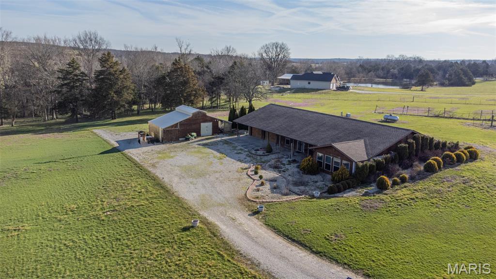 Discover the perfect blend of privacy, functionality, and rural charm with this unique 7.24-acre property. Nestled in a peaceful setting, the land is primarily open. Ideal for recreation or simply enjoying wide-open spaces, with a scattering of mature trees adding to it's natural beauty. A wet-weather creek runs along the back of the property. The earth-contact home offers energy efficiency and durability, designed to blend seamlessly with the landscape while providing year-round comfort. In addition to the home, the property features a well-built, insulated workshop with concrete floors—perfect for hobbies, storage, or business use. Whether you're looking for a homestead, a hobby farm, or a quiet country retreat, this property offers endless possibilities. This property sits less than 1/2 mile off the state highway and is less than 7 miles from town. Experience the space, versatility and tranquility you've been searching for.