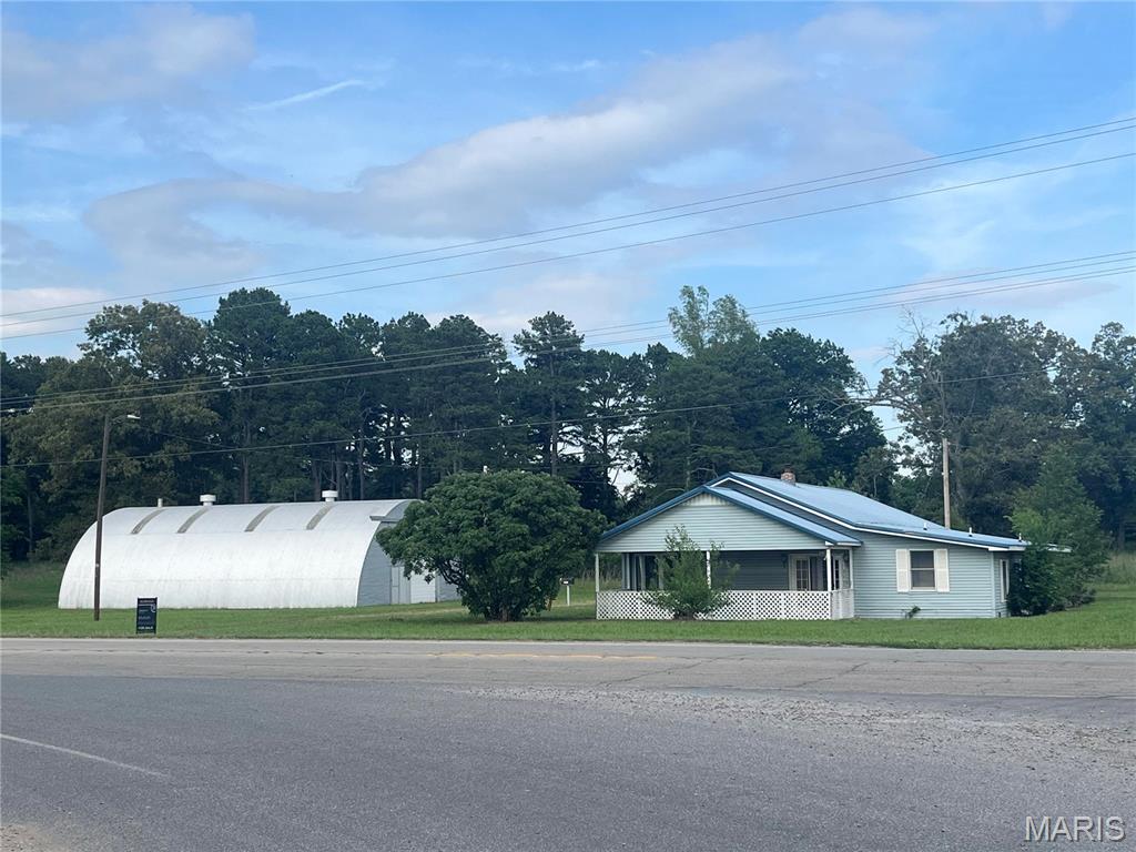 Opportunity awaits in Morley, Missouri! This 2,050+/- sq. ft. home sits on approximately 4 acres in the Scott County Central School District. Built in 1944, this property is full of potential and ready for your vision. With plenty of space both inside and out, this fixer-upper gives buyers the opportunity to renovate and make it their own. A standout feature is the large Quonset hut, offering excellent storage, workshop space, or endless possibilities for hobbies and equipment. The property offers plenty of mature trees for privacy and shade, along with over 400 feet of highway frontage, providing great access and visibility. Enjoy the peaceful country setting with room to spread out while still being conveniently located. Property dimensions are approximately 470 x 370. Bring your ideas and transform this acreage into something special!