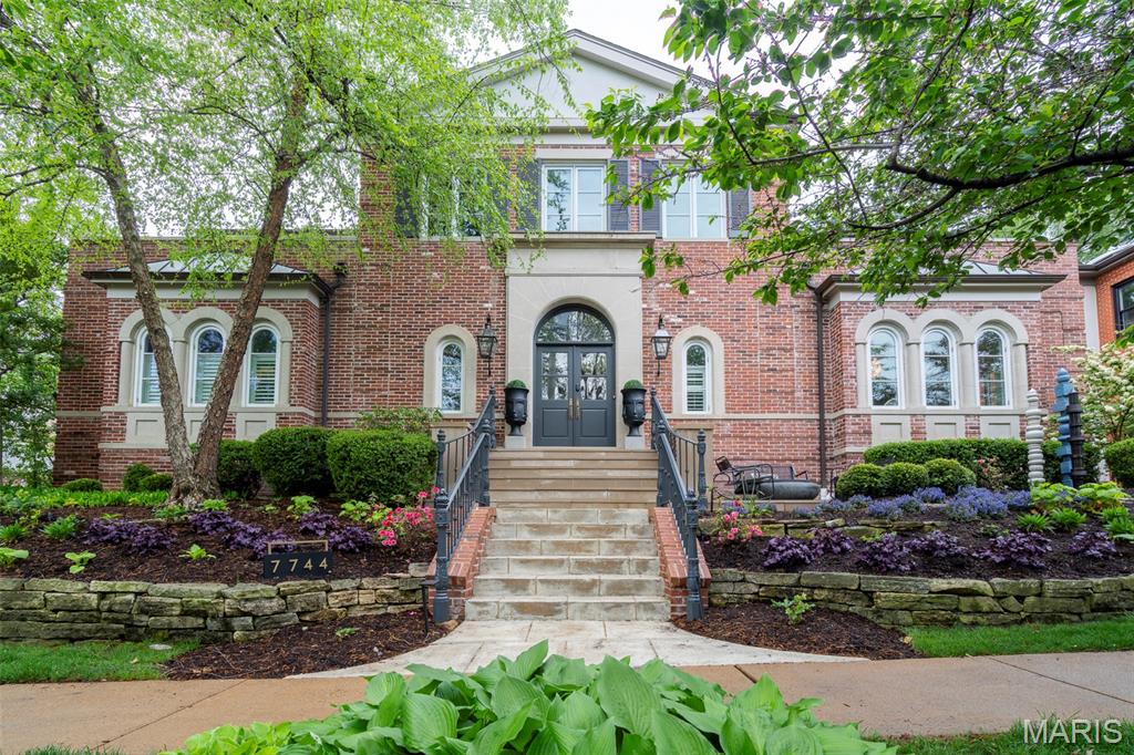 STEPS FROM DOWNTOWN CLAYTON! Here, you'll have it all. Come view this winner of multiple St Louis design awards!  An amazing home in a comfortable, upscale neighborhood where you can walk to downtown Clayton to enjoy it's unique lifestyle, with shops, restaurants, businesses...and, of course, the highly rated Clayton School District.  From the moment you approach the property, 7744 Pershing makes a lasting impression. Custom limestone front steps and a heated concrete driveway welcome you, while landscape lighting highlights lush greenery, curated by a professional landscape design team.  Custom gas lanterns at the front entrance add warmth and charm, creating a graceful transition from urban living to private sanctuary.
The automated irrigation system ensures the entire yard remains verdant throughout the seasons, while a lockable front vestibule offers both elegance and security, and a great place to have those expected packages delivered.
Upon entering the home, you are greeted by a grand two-story foyer that opens into the expansive living room. A hand-painted nightscape ceiling sets a serene tone, while recessed lighting throughout the home ensures the perfect ambiance for every occasion. Crown molding frames the ceilings, adding a touch of classic sophistication to every room.
The living room is a focal point, featuring a gas limestone fireplace, built-in bookshelves, and an integrated audiovisual center, creating the perfect environment for both relaxation and entertainment. A special highlight is the custom marble bar with dual waterfall edges, matching back bar featuring hidden lighting, recessed lighting, sink, icemaker, beverage cooler, wine cooler, and coordinated appliances.
The kitchen is truly the heart of the home, being completely reimagined featuring a Subzero built-in refrigerator, an induction cooktop, and dual convection ovens. This kitchen is a chef’s dream, designed for both functionality and luxury, with every detail crafted to perfection.
The primary suite offers a sanctuary of relaxation, with a spacious walk-out to a private patio. The master bath includes a Jacuzzi tub with a marble ledge, a separate shower, and custom cabinetry. A designated shoe and accessory closet separates his and hers walk-through closets, ensuring the perfect balance of space and privacy. An in-wall and ceiling sound system further enhances the experience, offering an immersive atmosphere that stretches throughout much of the home.
The home’s climate is controlled with a high-efficiency heat pump, installed in 2025, ensuring comfort year-round. The automated blinds and lighting system add a layer of convenience, with the center bedroom boasting views of the Clayton skyline through a charming Juliette balcony.
For the utmost convenience, two separate heated garages are included, one of which features double doors leading to the lower level. The property is also equipped with a tankless water heater, ensuring on-demand hot water throughout the home. There are laundry closets on both first and second floors.  One in the Primary bathroom closet! You must see this incredible home for yourself!