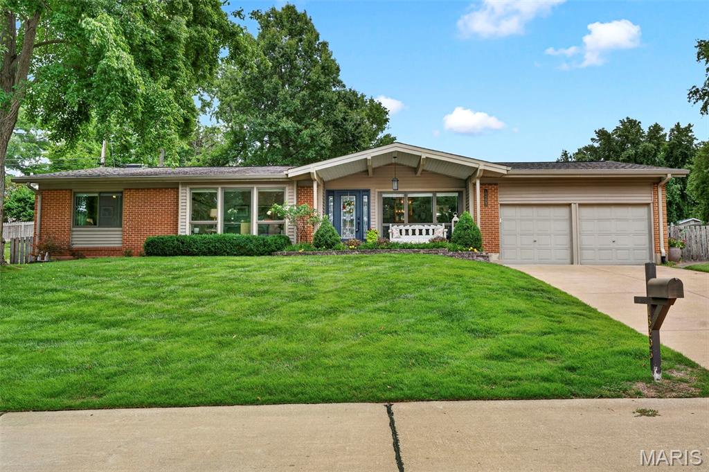 Welcome to this beautifully updated ranch in the highly sought-after Parkway School District, where mid-century charm meets modern comfort!  A dramatic vaulted ceiling with a rustic wood beam anchors the light-filled living room, where a stacked-stone, floor-to-ceiling fireplace creates a stunning focal point. Walls of windows and sliding glass doors flood the space with natural light and frame views of the private, fenced backyard and blossoming perennial garden beyond.

The open-concept design flows effortlessly into a dining area and a fully updated kitchen featuring granite countertops, a tile backsplash, and stainless steel appliances, perfect for everyday living and entertaining alike. New motorized privacy roller shades in the family room and eat-in kitchen, along with new 2.5" vinyl blinds in the bedrooms, living room, and dining room, add both style and convenience throughout.

With 4 bedrooms and 3 full baths, there's room for everyone. An enormous walk-in pantry combines seamlessly with the laundry and mudroom creating a uniquely functional space that keeps daily life organized. Downstairs, the finished lower level offers a spacious family/rec room with a stylish wet bar, bedroom, plus a versatile bonus room ideal for a home office, guests, workout studio, or game room, along with generous additional storage.

Step outside to your own private retreat: a spacious stamped-concrete patio overlooking a lush, landscaped corner lot, complete with an irrigation system, fenced backyard, and a hot tub ready for year-round relaxation.

This is single-level living at its finest! Thoughtfully updated, move-in ready, and perfectly situated in one of the area's most desirable school districts.