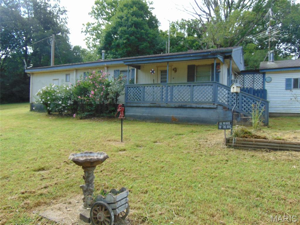 Nice older mobile home that has been added on to. Sits perfectly on a nice 2 acre lot near Current River. (Can also be purchased with a total of 4 acres or 7 acres.) Has a few outbuildings for storage, carport, and garage. Home is down U Highway just before the river. Agent owned.