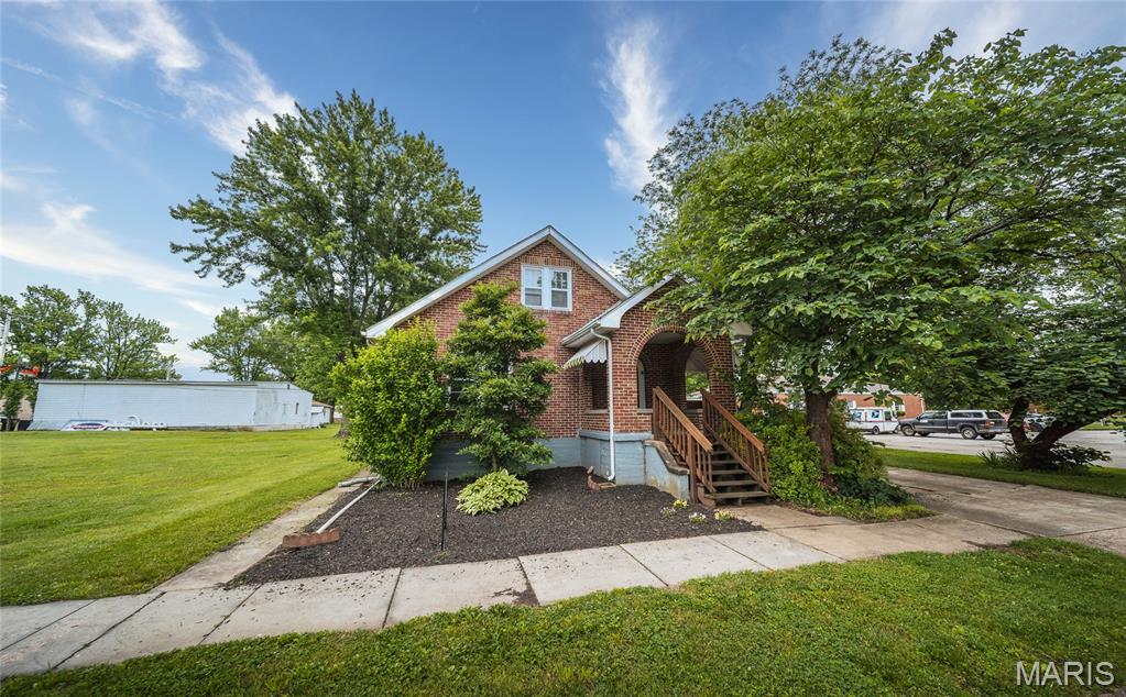 Charming cottage-style brick home with a fresh new makeover! This beautifully updated 3-bed, 2 full bath home features new flooring throughout, updated countertops, stainless steel appliances, refreshed bathrooms, and a brand-new bathroom added to the main-level suite. The spacious laundry/mud room offers everyday convenience, while the cozy fireplace (never used) adds warmth and character to the living space. Downstairs, the basement provides ample room for canned goods, storage, or even a storm shelter. Conveniently located close to shopping, dining, schools, parks, and all the amenities you need---this move-in ready gem blends charm, comfort, and practicality all in one.