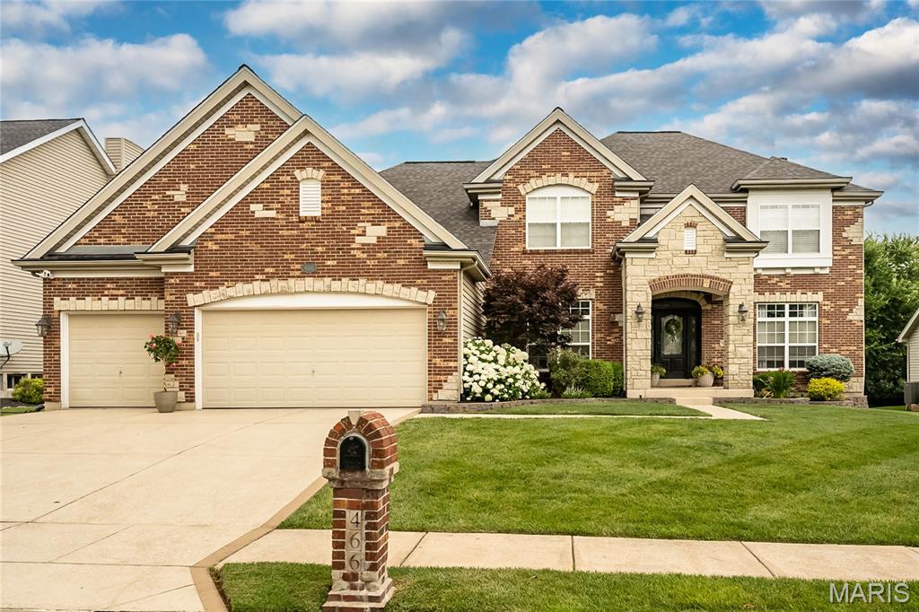 Nestled on a premium wooded lot in the prestigious Enclaves at Cherry Hills and served by highly acclaimed Rockwood Schools, this exceptional 5-bedroom, 4.5-bath residence offers over 6,263 square feet of impeccably finished living space designed for both elegant entertaining and everyday luxury. A striking brick and stone exterior, manicured landscaping and grand entry set the tone for the extraordinary spaces found throughout.
Rich hardwood flooring, extensive millwork, soaring ceilings and custom finishes create a timeless backdrop. The thoughtfully designed floor plan features a private main-floor office with French doors, formal dining room with butler's pantry, and an impressive great room anchored by custom built-ins and a stunning stone fireplace. The gourmet kitchen is a true showpiece, offering abundant custom cabinetry, granite countertops, oversized center island, stainless steel appliances, double ovens, walk-in pantry and an adjoining hearth room with vaulted ceilings and a cozy fireplace.

The luxurious main-floor primary suite serves as a private retreat, complete with an expansive walk-in closet and spa-inspired bath featuring dual vanities, soaking tub and oversized custom walk-in shower.

Upstairs, three generously sized bedrooms, all with walk-in closets, include a private ensuite retreat and two additional bedrooms connected by a Jack-and-Jill bath, thoughtfully designed to accommodate family and guests with ease.

The professionally finished lower level elevates entertaining to another level with a custom wet bar, spacious recreation area, fireplace, dedicated theater room, fitness room, fifth bedroom and full bath.

Step outside to enjoy the expansive deck overlooking the beautifully landscaped backyard and mature wooded backdrop, creating a rare sense of privacy and serenity. Residents enjoy access to the subdivision pool and clubhouse while remaining moments from shopping, dining, parks and everything that Wildwood has to offer!

From its impeccable condition and timeless finishes to its extraordinary living and entertaining spaces, this exceptional residence presents like a luxury showcase home!