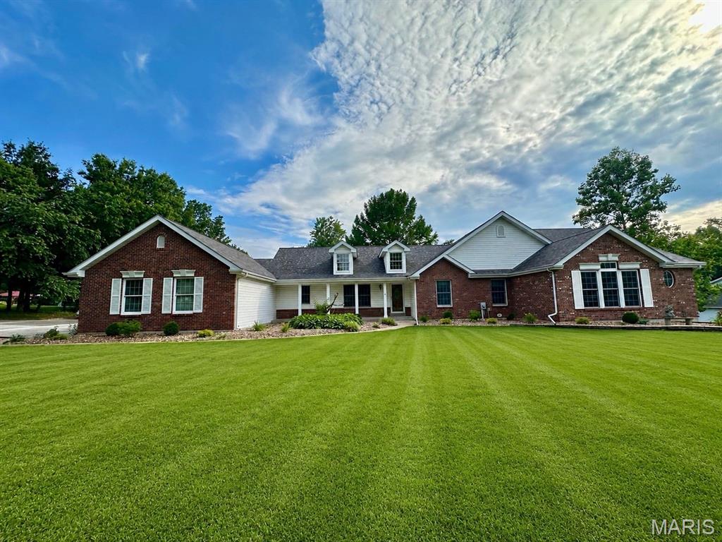 WELCOME HOME TO THIS 3K+ SQ FT SPRAWLING BRICK RANCH SITTING ON OVER 3 ACRES OF SERENITY. AS YOU PULL INTO THE TREE LINED NEW DRIVEWAY YOU INSTANTLY FEEL PEACE. THE MAIN ENTRANCE BOASTS BEAUTIFUL WOOD FLOORS AND VAULTED CEILINGS. THE CUSTOM KITCHEN CABINETRY AND KITCHENAID SS APPLIANCES  WITH EAT IN KITCHEN OVERLOOKS THE CONNECTING SUNROOM W/TILE FLOORS AND WINDOWS GALORE W/ THE PERFECT VIEWS OF THE BACKYARD ACREAGE. 3 BEDROOMS WITH ONE THAT LEADS TO 1k SQ FT LIVING QUARTERS WITH OWN HVAC & ADDITIONAL BEDROOM W/ 2 WALK IN CLOSETS, BATHROOM W/WALK IN SHOWER, FULL KITCHEN & FAMILY ROOM THAT IS A DREAM FOR  IN LAWS LIVING QUARTERS, OLDER CHILD SEPARATE SPACE, OR RENTAL INCOME W/ OWN EXIT DOOR LEADING TO DECK.  ALSO ON PROPERTY SITS A 40x20 SHED TO HOLD YOUR TRACTOR, BOAT AND SO MUCH MORE! HOME. COMES WITH WHOLE HOUSE GENERAC GENERATOR, WATER SOFTENER  AND CENTRAL VAC. BASEMENT IS WIDE OPEN AND HUGE AND READY FOR YOU TO FINISH!. ROOF & MAIN HOUSE HVAC NEW.
