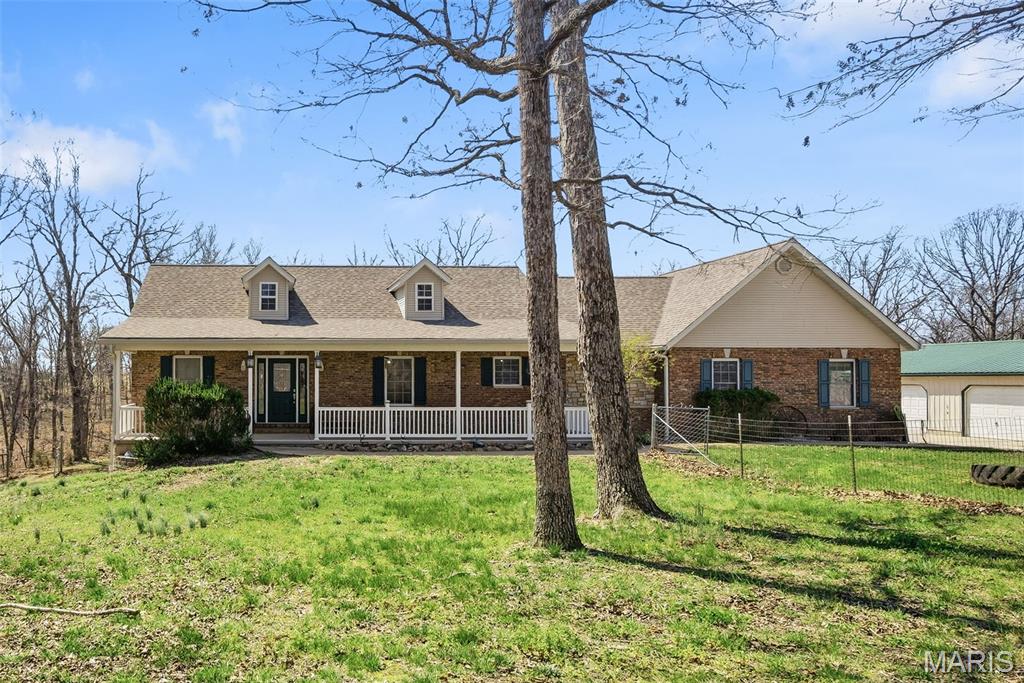 Equestrian-ready on approximately 16.82 acres—this private ranch-style home sits at the end of the road with a gated drive and the land and amenities to support your horse or small animal lifestyle. The 70’ x 40’ pole barn features four 10’ x 10’ stalls, and the property includes an outdoor round pen plus established trails for riding. Inside, you’ll find 4 bedrooms, 3.5 bathrooms, a spacious entry foyer, and a Great Room with a floor-to-ceiling masonry gas fireplace, vaulted ceiling, and French doors to the back patio. The open country kitchen offers newer appliances and a dining area, with main-floor laundry just off the kitchen and a convenient half bath. The primary suite includes a large walk-in closet, and the walk-out lower level is partially finished with a family room, bedroom, full bath, bonus office/den space, and a large storage/workshop area. Lots of outdoor workshop and storage space with frame constructed outbuilding, RV hook-up, a detached 40’ x 30’ fully insulated 2+ car garage with workshop, plus a 40’ x 13’ lean-to and fenced area.  Finally, an attached 29’ x 23’ insulated, drywalled, and painted 2-car garage with insulated overhead doors, two openers, and a service door. NOTE: This is relocation owned and they will only take a contingency for closing of home. They will not take a contingency for sale and closing.