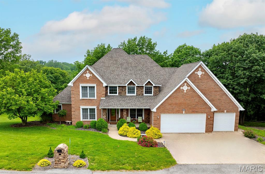 Stunning two-story brick home nestled on 3 acres in Hannibal, offering the perfect blend of country living and convenience. This beautifully built and maintained CUSTOM home welcomes you with a grand two-story foyer and an elegant office. The expansive two-story living room boasts an elegant picture window and an upstairs walkway overlooking both the living area and foyer, creating an open, airy feel. The gourmet kitchen is appointed with granite countertops and flows seamlessly into a bright breakfast room, sunroom, and deck—perfect for enjoying tranquil views of the woods behind the home. The large master suite includes a luxurious en suite bathroom and a generous walk-in closet for ample storage. This home also features a spacious 24 X 36 3-car garage with an additional garage downstairs. The lower level offers plenty of space to relax and kick back with an additional living room, fire place ,and built ins - it also has room for exercise! The lower level hobby room and garage offer expansive shelving an work space. Situated at the back of Fette Orchard Subdivision, this private setting offers all the benefits of the Fette Orchard neighborhood without the HOA. Conveniently located near the country club golf course, schools, shopping, and close to Interstate 36 access. Hannibal Regional Hospital is also nearby. This is the ideal home for both luxury and accessibility. Furniture is negotiable. Schedule your showing today!