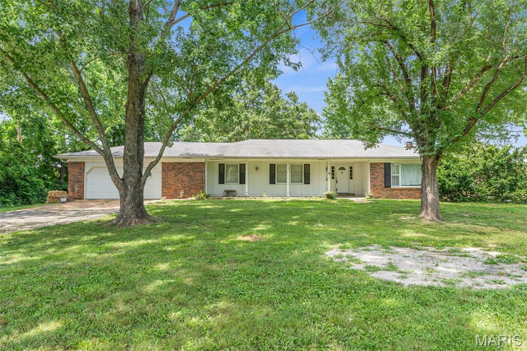 MULTIPLE OFFERS--HIGHEST & BEST DUE BY 4PM ON  TUESDAY 6/23 

This spacious ranch home sits on a stunning ~20.58 acre property, offering incredible potential for horse lovers, hobby farmers, or homesteaders.  While the home does need some work and has had some previous fire damage, it provides a solid foundation to create your dream home.  The space features a classic brick veneer front, with 3 bedrooms, and 2 bathrooms, and a nice sunroom, plus a 2-car attached garage for your convenience.
Outside, you'll find a charming barn on the property, perfect for animals, storage, or with a little elbow grease, a workshop.  The vast acreage is ideal for horses, hay fields, or other agricultural ventures.  With plenty of room to expand and make it your own, this property is a true diamond in the rough - ready for someone to restore it to its former glory.  Don't miss out on this amazing opportunity to own a piece of country paradise!
1-Year Home Warranty provided to buyers for peace of mind.