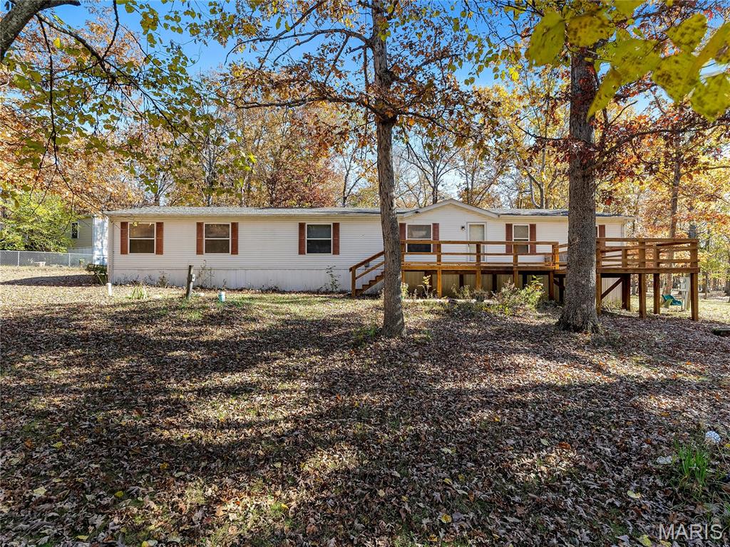 Seller is offering an automatic $3,000 towards closing costs for the buyer who puts this home under contract before June 1st!!!
Welcome to 10283 Green Bottom Dr in the beautiful lake community of Woodland Lakes! This property is so versatile, resting nicely on 4 multi purpose lots totaling 1.47 acres, the possibilities are endless! There is enough room to share this property with friends or family members, especially with the lot to the rear of the house having its own separate access off Burr Oak Rd, and its own garage with concrete floor! Turn it into a tiny house, Build another home, or use the ample space to privately park a camper or two while still being in close proximity to the main house. So many updates have been done to this home recently including a newer furnace and AC, new roof, newer tub and surround, some new fixtures and some new paint. Walking through the front door you are greeted by an extremely spacious and open floor plan! This manufactured home is MASSIVE, boasting 2,240 square feet of living space! Plenty of room to entertain!! The laundry room is spacious as well and the washer and dryer stay.  Each of the 3 bedrooms is generously sized, with the primary featuring a walk-in closet, and private bathroom with a soaking tub. If fishing, boating, swimming, and fun are your thing, then this is the home for you! Woodland lakes has so much to offer with multiple lakes, pool, and so many amenities, there is always some fun to be had! Don't let this one slip away, schedule your showing today!