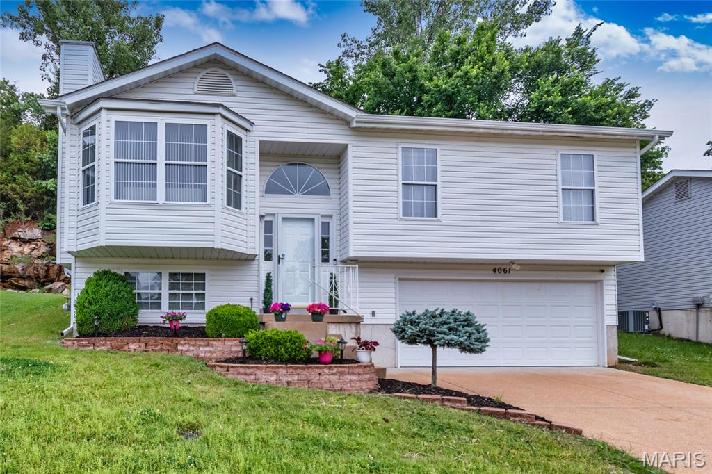 Welcome to 4061 Whitehall Dr. - This Beautiful Split Level home & Location are sure to please. Pull up to a New roof & siding, come inside to Freshly painted walls & trim. Checkout the spacious living room with plenty of natural light, wood flooring & gas fireplace . Kitchen has cozy dining area, stainless steel appliances with pantry, island & soft closing drawers. Full hallway bathroom, 2 bedrooms have newer carpet, ceiling fans & plenty of closet space, Primary bedroom has full bathroom, closet space & newer carpet. Put your finishing touches on Lower level. Lower Level has gas & electric washer / dryer hookup with roughed in bathroom. Water Heater, HVAC 1yr old, step into your clean 2 car garage. Don't miss out on this home .
