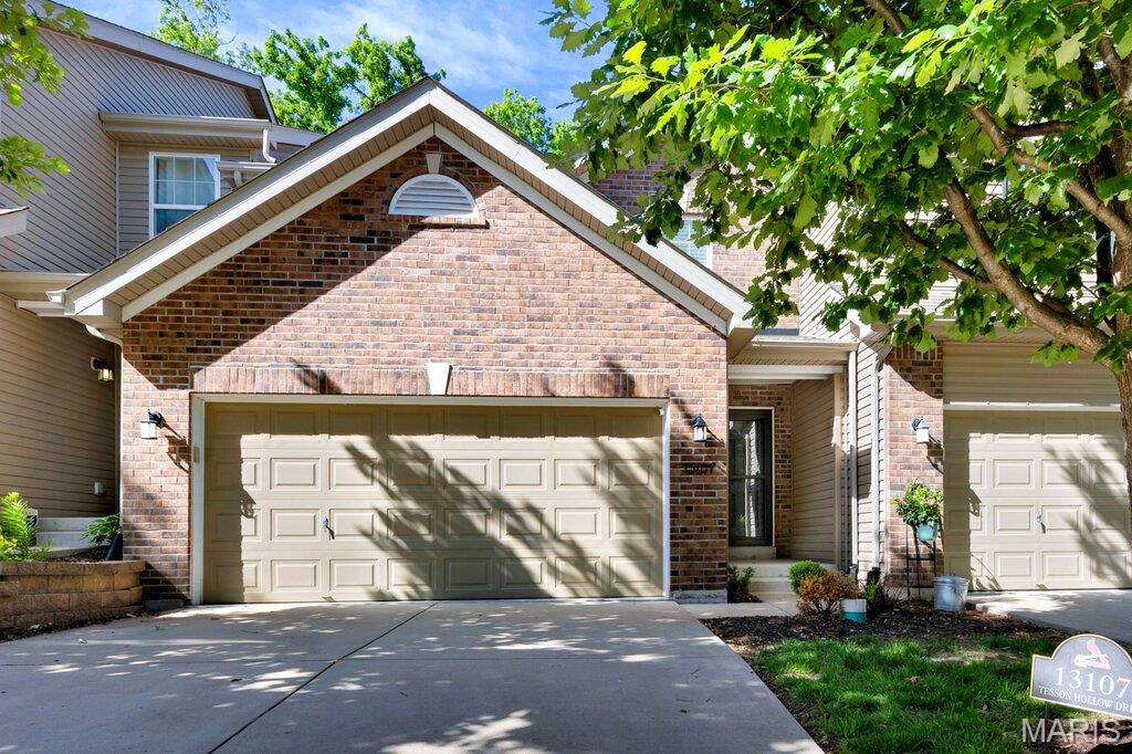 Welcome to 13107 Tesson Hollow Drive, a beautifully maintained South County townhouse tucked at the end of a quiet street and just minutes from Highways 270, 44, and 55.  This 2-bedroom, 4-bath (2 full, 2 half) home offers easy living with a 2-car garage and a location that makes daily life a breeze, right across from the mailboxes and surrounded by sidewalks and streetlights perfect for evening strolls.  The kitchen is ready for both everyday meals and weekend hosting, featuring durable cabinetry, stainless steel appliances, generous counter space, a pantry, breakfast bar, and a sleek electric range.  The bright breakfast room offers low-maintenance vinyl flooring and opens through a sunny atrium door to your covered, extended patio.  The living room invites you to kick back and stay awhile, with cozy carpeting, a ceiling fan, and large windows that fill the space with natural light. A welcoming foyer with coat closet and powder room keeps things tidy and functional.  A stair lift (removable if desired) adds ease of mobility.  Upstairs, convenience continues with laundry just steps from both bedrooms - no more hauling baskets up and down! The secondary bedroom offers a walk-in closet, ceiling fan, and access to a full hall bath. The spacious primary suite feels like a retreat, complete with a tray ceiling, 2 walk-in closets, and a private en-suite featuring a step-in shower and separate water closet.  The partially finished basement expands your living space with a versatile rec room, ideal for movie nights, home office, workout space, or game room. An egress window brings in natural light and offers the potential for a future bedroom, while a half bath and additional storage areas add even more functionality.  Set in a community designed for connection, with sidewalks and streetlights encouraging you to get out and enjoy your surroundings, this home truly checks all the boxes.  Don't Sleep on Your Dream Home, Sleep in It!