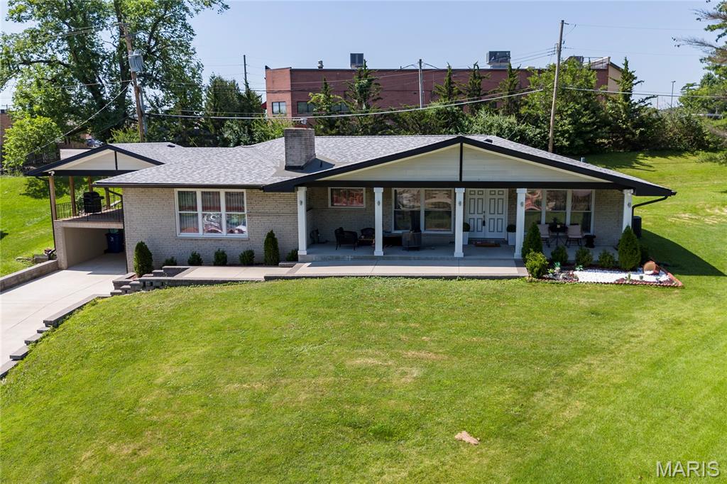 Beautifully maintained and updated brick ranch in the highly sought-after Sunset Hills community, within the award-winning Lindbergh School District. The inviting main level features a spacious family room with a charming brick-surround fireplace, seamlessly flowing into an open-concept kitchen and breakfast area. The kitchen is appointed with marble countertops, rich cherry cabinetry and modern stainless steel appliances all with neutral finishes. An additional generously sized family room offers versatile living space and provides direct access to a covered patio-perfect for outdoor entertaining, overlooking the level backyard. The main floor includes four well-appointed bedrooms and two full bathrooms. The finished lower level expands the living space with a sleeping area, full kitchen, full bathroom, a large custom laundry room and abundant storage. Additional highlights include a private backyard lined with mature trees and exceptional parking, with garage and covered driveway space for up to four cars. At the end of a quiet cul-de-sac come move right in!