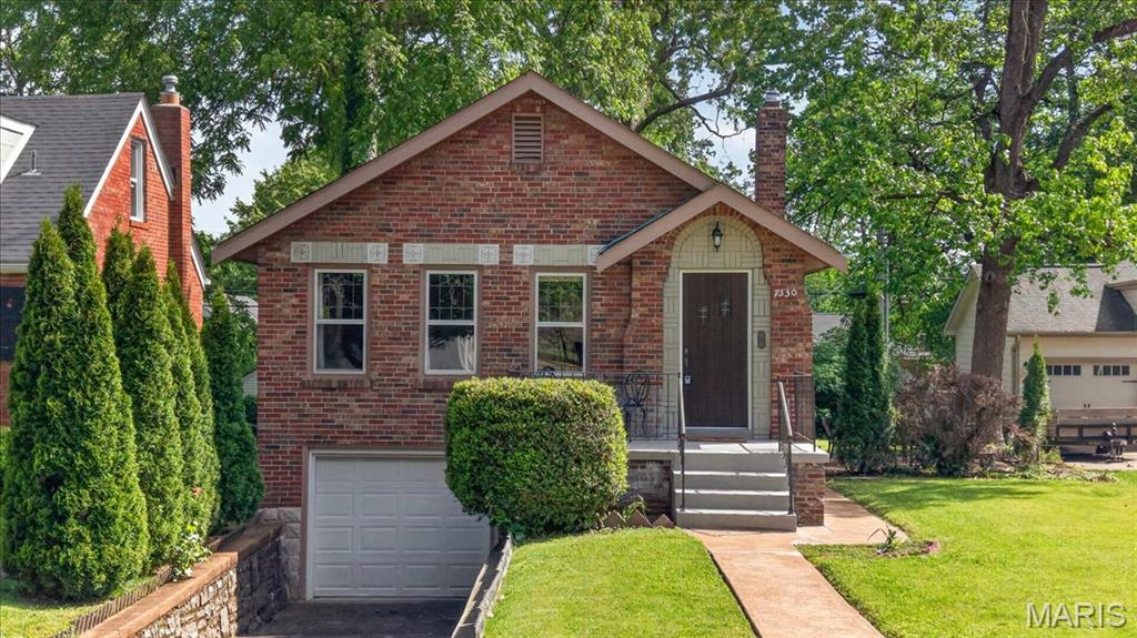 This charming and well-preserved all-brick bungalow blends timeless character with an incredibly functional layout in the heart of University City. Beautiful original woodwork and historic details shine throughout, creating a warm and inviting feel from the moment you step inside. The open flow between the living room, dining room, and kitchen is thoughtfully defined by subtle architectural transitions that give each space its own identity while maintaining an airy, connected feel.

Two spacious bedrooms run parallel to the main living area and are connected by a classic Jack-and-Jill bathroom, maximizing the home’s footprint with a layout that feels both efficient and comfortable. Natural light fills the home, complementing the cozy atmosphere and highlighting the craftsmanship throughout.

The unfinished lower level is bright, clean, and well-lit, offering excellent flexibility as a recreation space, laundry area, workshop, or additional storage. Outside, enjoy both a welcoming front open terrace and a private back patio—perfect spaces for relaxing or entertaining. A tuck-under garage adds everyday convenience and additional storage potential.

Full of charm, character, and timeless appeal, this is a home that simply feels good the moment you walk through the door.