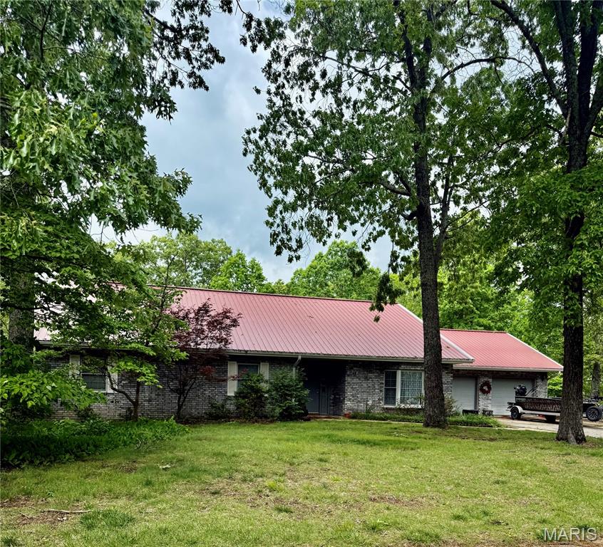 Rockwood Estates Is where this unique "One of a Kind " home is located.  Everything on One Level .....No stairs to get inside front door and no interior stairs.  This 3 Bedroom home is PERFECT....One Owner that has maintained every inch of their home.  Lots of updates you must see !!!  There is engineered Hardwood installed in all common areas.  The  Large open floor plan with a beautiful Custom Gourmet Kitchen that was totally remodeled in .  Quartz countertops 5 burner LP cooktop, 700cfm Range Hood vented to the outdoors....Nice big living room, separate dining room and Eat In Kitchen with a large back deck off the breakfast nook.  All 3 bedrooms are larger then most other local homes.  Did  I mention the oversized attached garage that makes  a great " Man Cave".   This pretty spatial home sits on over 1 acre of land...the Lot is flat and perfect place to put in a pool,  kids outdoor activities....possible a tree house....only your imagination limits the possibilities.  The  Big back Deck was also renovated with Tre Decking and New Rails ...Off the deck is perfect He Shed/ She Shed... nearly 150 Sf with slab on grade flooring.  the shed dimensions are 12x16 with an additional 6x16 covered mower storage.  This home is located about 10 minutes from the front gate of Fort Leonard Wood. ... 5 minutes from shopping and local eateries in St Robert MO...Waynesville RVI school district.