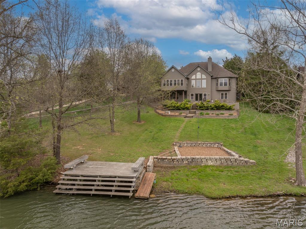 Enjoy true lakefront living at Innsbrook Resort with sweeping views of Silverfox Lake and a home that has been fully updated. This furnished property offers a comfortable, move-in ready option for a full-time residence or weekend retreat. Step inside to a bright main living area with a vaulted ceiling and a wall of windows that frame the lake. The fireplace has been redesigned with rustic stone and custom lighted built-ins, creating a warm focal point. It's the perfect spot to relax or wind down with a movie in the evening. A professionally installed new staircase railing adds a clean, updated look, while new flooring throughout enhances the overall feel of the home. The kitchen is both stylish and functional with granite countertops and stainless steel appliances. A cozy breakfast nook is ideal for casual meals, while the expanded dining area gives you space to host family and friends. The primary suite is set to take full advantage of the lake views. It features tall ceilings, a large walk-in closet, and a beautifully updated bathroom with a custom tile shower, separate tub, double vanity, and dedicated makeup area. A second bedroom and another fully remodeled bathroom are also located on the main level. 
The lower level adds even more living space with two large bedrooms and a spacious central area that works well for game nights, TV room, or additional lounge space. The third bathroom has been completely updated with the same quality finishes. You will also find plenty of storage along with room for a workout area or hobby space. One of the standout features of the home is the main floor three-season room. Surrounded by windows, it offers uninterrupted lake views and a great place to relax at the end of the day. Step outside and follow the low-maintenance landscaping down to your private dock where you can fish, swim, or paddleboard on Silverfox Lake. Located close to the golf course and dining, this home combines convenience with a peaceful setting. Offered furnished with a few exclusions, it is ready for you to start enjoying the Innsbrook lifestyle right away.