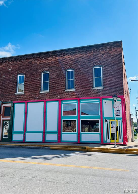 Amazing Investment Opportunity!!  In the heart of downtown Perry, MO sits this amazing commercial space! Here is your chance to own an income generating property! The building currently has amazing tenants, with a current lease in place, plus paying all utilities!  You will fall in love with this building the minute you walk in the door! The soaring ceilings and exposed brick walls are beautiful and everyone that walks in loves the atmosphere. The main level of this building is currently set-up as a restaurant, but it could also be the ideal location for a boutique, coffee shop, event space or office space in the future. The second level of the building has an additional 2,460 square feet of space that is an open canvas. An ideal space for apartments! Building is being sold "AS-IS".  Seller is selling the property with the current lease in place through July 2026, please contact listing agent for more details. Call today for your private appointment to see this amazing space!