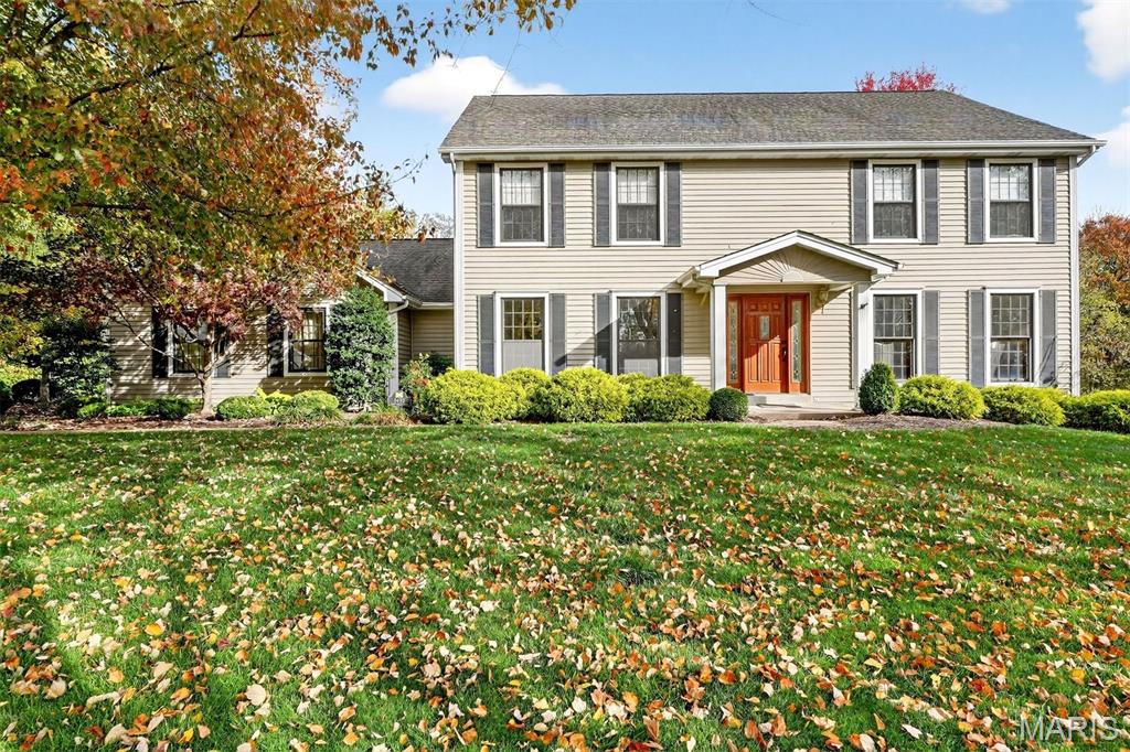 Welcome to Mason Valley! This classic center-hall, two-story home combines timeless charm with comfortable living. The main level features a formal dining room and a spacious living room that flows into a cozy family room with wood paneling, built-in bookcases, and a gas fireplace. The eat-in kitchen impresses with a large island, stainless steel appliances, gas cooktop, double ovens, built-in refrigerator, coffee bar, and ample storage. A powder room, laundry, and drop zone lead conveniently to the oversized three-car garage. Three sets of doors open to a beautifully landscaped, private backyard oasis with a recently updated gunite pool featuring a diving board, deep end, new decking and coping, and newer pool equipment. There’s plenty of green space, and the yard backs to private grounds. Upstairs, the primary suite overlooks the pool and offers double sinks, a soaking tub, a separate shower, and a large walk-in closet. Three additional bedrooms and a full bath complete the upper level. The finished lower level includes a bright rec room with a wood-burning fireplace, wet bar, half bath, and space for a workshop, storage, and a wine cellar. Mason Valley offers year-round neighborhood activities, tennis courts, and easy access to Queeny Park, as well as restaurants, shopping, coffee, and ice cream. Conveniently located near top-rated public and private schools, this home truly has it all.