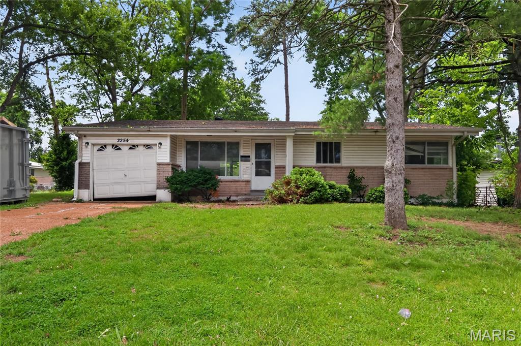 Welcome home to this charming 3-bedroom, 2-bathroom ranch nestled in the quiet Hathaway Manor subdivision of Unincorporated St. Louis County. Boasting 1,044 sq. ft. of main-level living space, this single-family property greets you with a welcoming covered front porch.  Inside, enjoy an open-concept living and dining room combo featuring hardwood floors throughout and durable ceramic tile accenting the kitchen. The main level hosts three comfortable bedrooms, including a primary suite with an attached en-suite bath.  Step outside to a manageable lot with an attached 1-car garage. Plus, find incredible storage potential or future expansion opportunities in the massive full basement. Located in the Hazelwood School District with seamless access to everyday amenities