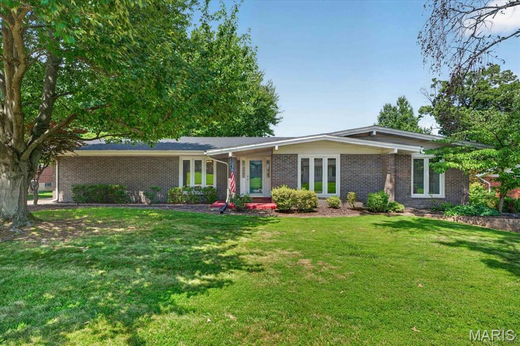 This home sitting on the 3rd hole of the Florissant Golf Club has been meticulously maintained by the only 2 owners. The sellers inform me that will you see fabulous sunsets from here. Predominately brick ranch with approximately 2111 sq ft on the main level and another 168 sq ft of living space for the additional sun room. Most of the house has hardwood floors with some vinyl and newer carpets. All the interior including trim, white 6 panel doors, walls and ceilings have been newly painted and there are a lot of new light fixtures. All the windows are double pane thermals and the windows in the sun room are Pella. All the bedrooms have overhead lights so ceiling fans, if desired, could be easily added. The eat-in kitchen has wood cabinets that are stylish and in very good condition. There are also a full array of stainless steel appliances which have never been used and all remain. The primary suite is 22 x 11 with a w/b fireplace, a dressing table, and an 8 x 5 walk-in closet. The other 3 bedrooms are all sizeable. My guess is that this house will get occupancy for at least 8 so if you have a large or growing family this might be an ideal purchase for you. The spacious basement, although not finished, has been framed in and there is a roughed-in full bath. The electrical panel was replaced in 2024 and the gas furnace is  90% efficient. The 2 car rear entry garage with opener has been freshly painted. Off the sun room is a patio and from here all you see are the rolling green hills and trees of the golf course. This home is immaculate and move in ready.