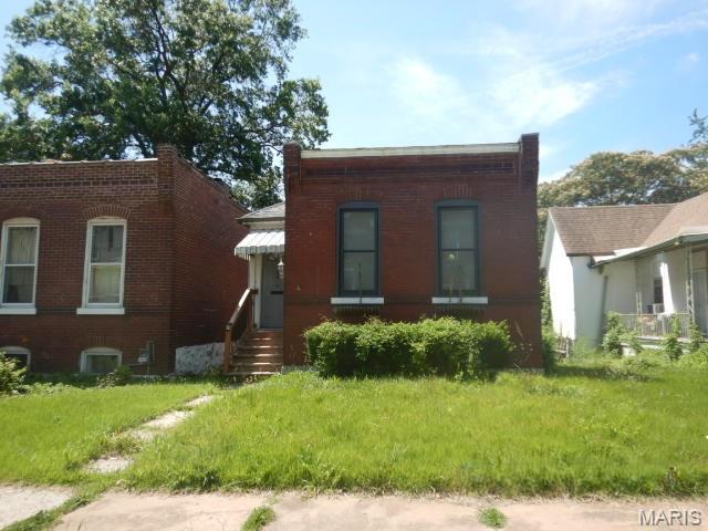 Cute bungalow with tons of potential.  It's a 2 bdrm, 1.5 bath home with character and charm.  Exposed brick feature wall in living room, roomy kitchen with a peninsula/breakfast bar, tile floor, and then you step out back to a deck and discover a fenced rear yard, parking pad and a covered carport area.  The basement has some finish that provides additional potential including the 1/2 bath already installed.   Don't miss out.