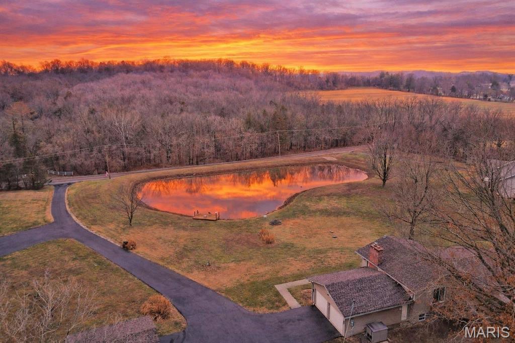 Country living just steps from city amenities! This gorgeous multi-level property is both rare & unique with just over 3 acres of flat & useable land including your very own, fully stocked lake for fishing & swimming. Wind up a recently re-sealed asphalt driveway to pleasing & low maint. curb appeal. The exterior of the home is improved with brick front accents, vinyl siding, wrapped soffits, architectural shingles & large covered front porch with views of the lake. Walk inside to an open floorplan w/fresh paint, newer flooring & numerous updates. Large family area features wood laminate flooring & ceiling fan. Custom kitchen includes 42 in cabinets w/crown moldings, tile backsplash, large center island, SS appliances, breakfast bar & dining area. Walk up a small flight of stairs to a master BR suite with private master bath, 2 add BR's & 2nd fully updated bath. Finished LL adds to your useable square footage with a family/rec room, full woodburning fireplace insert w/brick surround, 4th bedroom, 3rd full bathroom w/custom tile enclosure & laundry area.  Down yet another small flight of stairs is a finished room & tons of storage space.  On the exterior you'll find a 2-car attached garage, external garage/workshop w/propane stove & 100 amp panel, garden area & fully stocked private lake with dock for fishing.  RSD, minutes from 44 and shops/restaurants in downtown Eureka.
