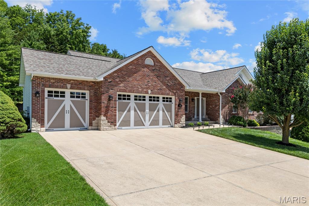 Beautifully maintained and thoughtfully designed, this exceptional ranch offers the perfect blend of spacious one-level living, timeless finishes, and an open floor plan designed for both everyday comfort and effortless entertaining. Soaring vaulted ceilings, rich hardwood floors, elegant arched openings, and abundant natural light create an inviting atmosphere throughout. At the heart of the home, the impressive great room features soaring ceilings, a gas fireplace with an elegant mantel, and expansive windows that fill the space with natural light. The adjoining kitchen is equally impressive, offering custom cabinetry, stainless steel appliances, a center island with seating, pantry storage, and abundant prep space. The spacious breakfast room opens directly to the patio, creating a seamless connection between indoor and outdoor living, while the formal dining room provides an elegant setting for holidays, celebrations, and gatherings with family and friends. Privately situated, the expansive primary suite is a true retreat, featuring vaulted ceilings, generous proportions, and plenty of space for a sitting area. The ensuite bath offers dual vanities, a relaxing soaking tub, separate walk-in shower, and a spacious walk-in closet. Two additional bedrooms, a well-appointed hall bath, and a convenient main-floor laundry room complete the main level. The expansive walk-out lower level offers incredible potential to expand the home’s living space, providing endless flexibility for future finishing while still offering abundant storage. Surrounded by mature trees, the backyard offers a peaceful, private setting that feels like your own secluded retreat. Whether you’re enjoying the view from the patio or simply appreciating the quiet natural surroundings, the outdoor space provides the perfect extension of the home’s warm and inviting atmosphere. Ideally located just minutes from Gravois Bluffs, you’ll enjoy exceptional convenience with an outstanding selection of shopping, dining, entertainment, and everyday amenities, all just moments from home. Offering the perfect blend of spacious living, quality craftsmanship, and an unbeatable location, this exceptional ranch delivers everything today’s buyers are looking for, all within one of Fenton’s most sought-after communities.