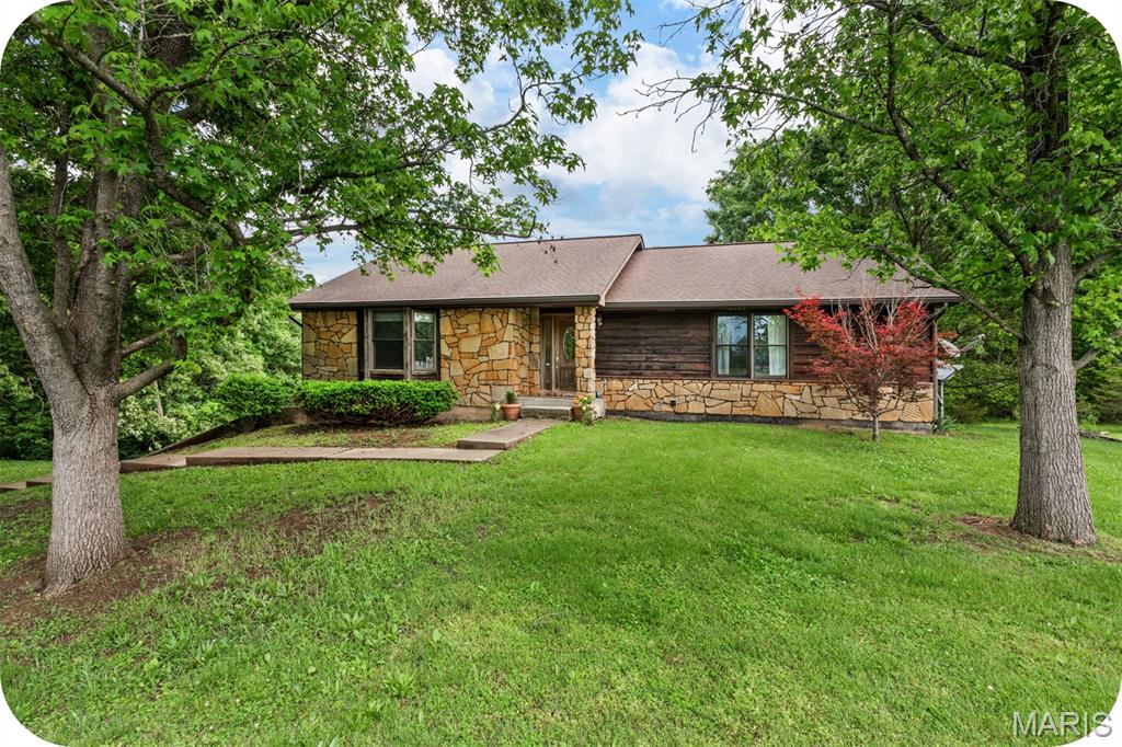 A rare opportunity to own a magical home in a magical location! This property has it all. Situated on over 2 acres of land, this 3-bedroom, 3-bathroom home has a ton of space, just look at the size of those rooms! (floor plan in photos). On the main floor there is a huge living room with built-in bookshelves and a bay window, a large eat-in kitchen, separate dining room, full bathroom, a primary bedroom with attached full bath and a walk-in closet, and a second bedroom with a walk-in closet as well. In the finished basement you will find yet a third full bathroom, another bedroom, and a second living room/entertainment room that has outdoor access. Also in the basement is a laundry room with extra storage space. The two-car tuck-under garage is super convenient, and there is room for 3-4 more cars in the extra space outside. The large yard offers plenty of room to add a shed, garden, or even a pool! The real charm is the quiet nature of the property, surrounded by trees and many species of birds (over 75!), it is perfect for star gazing and enjoying nature. The other convenience of the property is the close proximity to I-55 and US-67, being close to several parks and conservation areas, and being only a beautiful 15-minute drive to three nearby cities. The added bonus? This home is in the Festus school district! A perfect home for an investment or for those looking to fix up the home while residing in it. Schedule your showing today! *Please view the seller's disclosure.