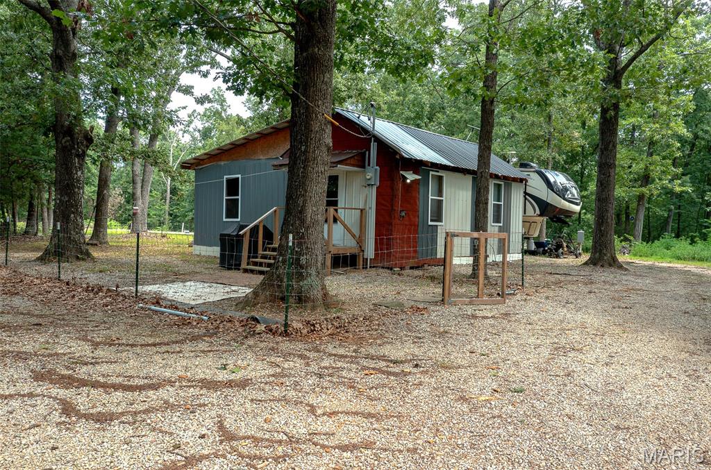 Escape to your own private retreat with this cabin situated on 19.59± wooded acres offering endless possibilities. Whether you're searching for a hunting property, weekend getaway, or a place to build your forever home, this property is ready for your vision. The existing cabin measures approximately 12' x 24' and is currently utilized as a one-room living space, with the opportunity to finish the remaining portion for additional living area. It is equipped with electric service, a window air conditioning unit, and a propane wall heater. Much of the groundwork has already been completed. The property features a 16' x 80' concrete pad ready for a manufactured home, a drilled well, and electric already on-site. A septic system has been installed it just needs to be completed and connected, making this an excellent opportunity for someone looking to finish the project to their needs.
The acreage is primarily wooded with a small area of open ground, providing privacy, abundant wildlife, and excellent recreational opportunities. With no restrictions, you'll have the freedom to make it your own. Enjoy the peace and seclusion of country living while remaining conveniently located just 20–30 minutes from Fredericktown, Farmington, and Perryville.