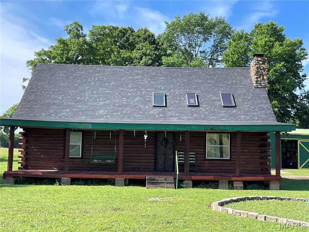 Enjoy the beautiful views from the covered front porch of this cozy log home. The open floor plan, living room, kitchen and dining room with vaulted ceiling, stone fireplace, offer the perfect place to spend a night in. Updated kitchen and flooring throughout. Spacious bedroom, with adjoining smaller room, could be an office or nursery. Laundry and main bath combo with tub and shower. Upstairs boasts another bedroom with dual closets, could be petitioned off to make two rooms. Level, manicured yard for family gatherings, with plenty of space for yard games or just sitting around in the shade. Covered front porch and back porch, span the length of the house. Two bay garage and workshop offer over 800 sq. ft of working area with an additional 360 sq. ft of space which includes a lofted area. Clearwater Lake, Black River and Sam A. Baker are just a few of the wonderful amenities that are just right down the road.