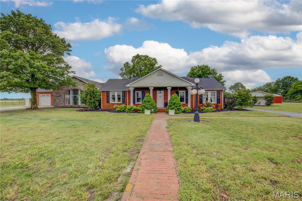 This " ALL BRICK" 4 Bedroom home, 3 of which are ensuites, is located on a paved road and sits on an ACRE offering you Upscale Country Living without the dust. While your nearest neighbor is over a 1/4 mile away you are just minutes from shopping, hotels & grocery stores. The home is Solid and Upgraded and was fully renovated and remodeled in 2008, with over 2,000 square feet of additional living space added and upgraded to the existing home. The NEW roof covering was installed in 2018. For those with a home office you will appreciate that Fiber Optic Cable is available. Water is supplied by a county water system. The detached building, currently used for storage, offers many options for secondary living quarters or that Man Cave you've been wanting. Low taxes, virtually maintenance free exterior and priced UNDER appraised value @ less than $118 per square foot be sure to put this one on your "To see List". The adjoining land owner is willing to sell or lease an additional 3 1/2 acres which includes 2 Barns, Loafing shed, Metal carport & Fencing if you are interested in having livestock.