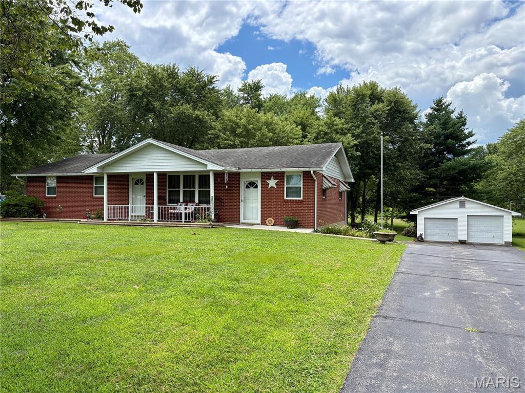 Brick ranch on 1.128 acres in Jackson R-II School District offering the space, storage, and shop setup buyers are looking for. With 4 bedrooms, 2.5 baths, multiple living areas, and both attached and detached garage space, this property is well suited for buyers needing room for vehicles, hobbies, tools, equipment, or storage.

The main level includes 3 bedrooms, 1.5 baths, an eat-in kitchen, living room, and large family room with buck stove. Hardwood flooring is believed to be under portions of the main-level floor coverings, with closet floors offering a glimpse of what may be underneath. The walk-out lower level adds a finished sleeping area/bedroom, full bath, laundry, and storage.

Outside, the expansive driveway provides easy access to both attached and detached garage spaces, including a heated shop with electricity, double doors, and one oversized bay. The carport currently serves as a covered patio, adding usable outdoor space without sacrificing parking flexibility. Updates include HVAC in 2020 and water heater in 2019. Brick exterior offers added sound buffering and efficiency-minded insulation benefits.

Home is no longer owner-occupied, so limited information is available; however, seller is not aware of concerns and resided here from 1978 until recently. Properties with this combination of acreage, brick construction, garage/shop space, and Jackson schools deserve a closer look.