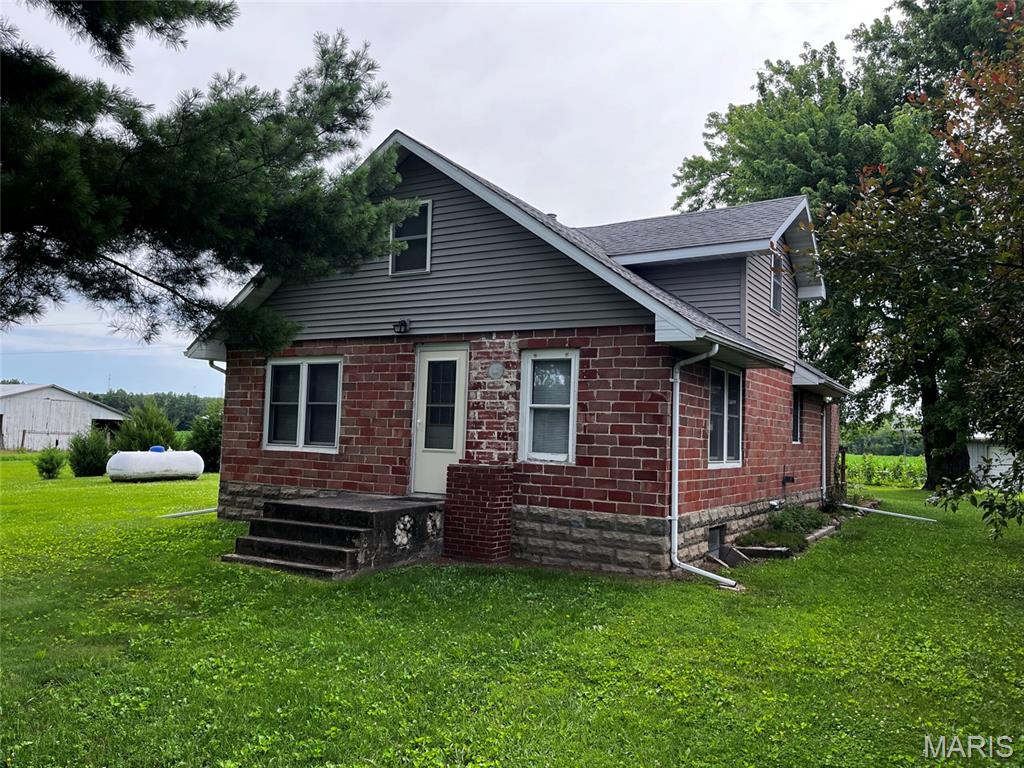 A nice opportunity here for a home offering old-fashioned simple living.  This home offers up to 5 bedrooms with one on the main floor and up to four small bedrooms upstairs.  There is 1,414 square feet of living space with a full basement.  It includes a garage/workshop, 24' x 30', with a concrete floor, 2 overhead doors and a separate one car garage.  The grounds are extremely well manicured with several flower beds and 2 large garden spots and several beautiful trees including fruit trees.  A small older grain bin offers additional outdoor storage.  Appliances convey and include an electric stove/range, 2 refrigerators, washer and dryer.  Propane forced air heating and central air conditioning were updated in 2014.  This property offers very affordable living as utility history shows low costs of maintenance.