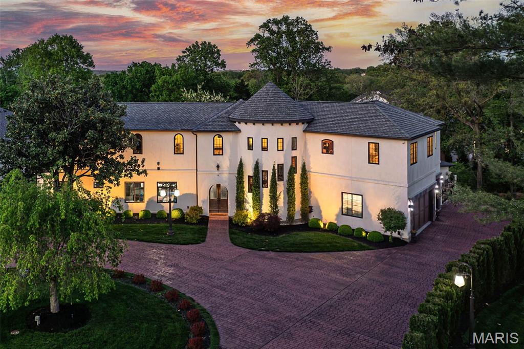 Back on market, no fault of seller.Experience West Coast-inspired luxury in this completely reimagined 6-bed, 5-bath French country-style estate, offering 4,400+ sq ft of living space on more than half an acre in the Parkway South district. Step into a grand entry foyer with soaring ceiling, columns (hand-carved mahogany shipped in from Indonesia), and arched walkways, flowing into an elegant floor plan with designer finishes throughout. Custom-designed Chef’s kitchen dazzles with extensive custom cabinetry, granite counters, an expanded center island, and SS appliances with views overlooking your heated saltwater pool. The outdoor pavilion, with a built-in grill and a pizza oven, is complete with a full brick fireplace for those chilly evenings; this home invites entertaining with ease and offers plenty of privacy.
 From the foyer, the spiral staircase leads you to an expansive bonus room perfect for additional living space. The primary master suite offers privacy tuck away from the hustle and bustle of life and is completed with his and her walk in closets, spacious primary bath complete with double vanity, walk in shower and more,  away from the primary suite, you will find a second kitchen which is part of a complete apartment/in-laws’ quarters above the 3-car garage, complete with its own private entrance. With walnut floors, rec room, office, and private bedrooms—ideal for multigenerational living or extended stays—two separate laundry areas were thoughtfully placed to offer many options while taking advantage of this prime location, minutes from shopping, schools, and major highways. This is a sought-after location.
Added to the home is a central vacuum system and an in-ground sprinkler system for easier maintenance of the grounds and landscaping. This home is truly a blend of comfort and West Coast-style sophistication. What a transformation this residence experienced as it was completely rebuilt in 2019.
STL county occupancy inspection PASSED!