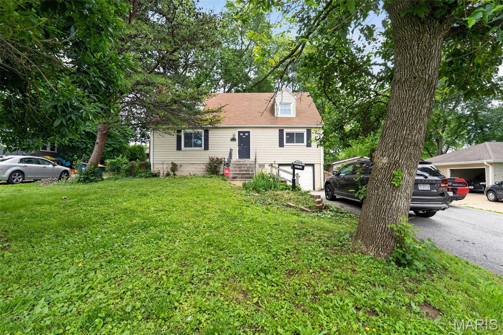 Completely renovated and move-in ready, this spacious 4-bedroom, 2-bath home offers over 2,100 square feet of living space in the heart of St. Ann. Featuring beautifully refinished hardwood floors, an updated kitchen with newer cabinetry, stainless steel sink, ceramic tile flooring, and abundant cabinet space, this home blends classic charm with modern updates. Both full bathrooms have been tastefully remodeled with custom tile work and updated fixtures.



The main level offers generous living and dining areas plus two large bedrooms, while the upper level includes two oversized bedrooms with new carpet and ample closet space. A wood-burning fireplace adds warmth and character to the living area. Major updates include newer roof, siding, gutters, windows, plumbing, water heater, and lighting.



Enjoy the oversized rear deck with canopy overlooking a fenced backyard with mature trees — perfect for entertaining or relaxing. Additional features include a walkout basement, attached oversized garage, and extended parking pad with room for multiple vehicles.

Conveniently located near shopping, restaurants, highways, and Lambert Airport in the desirable Ritenour School District.