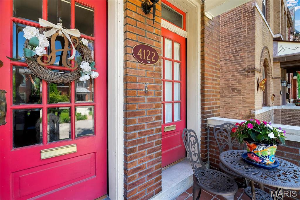 This charming, fully-updated home in Historic Shaw checks all the boxes! Once a duplex, the all-brick home now features 3 great bedrooms, a 2-car garage and a flexible floor plan. Sleek hardwood floors run throughout the main level. In the living room, a decorative fireplace is flanked by built-in bookshelves with beautiful leaded glass doors. The spacious formal dining room features original corbels and crown molding for character, as well as recessed lighting for convenience. The dining room leads into a welcoming, open kitchen and family room, with plenty of space for casual dining, relaxing, or working from home! The well-designed kitchen boasts crisp white cabinets, cool marble countertops, a tiled backsplash and a gas range. The icing on the cake is a screened porch - perfect for morning coffee al fresco! A convenient laundry room and a bright half bath complete the main level. Front and back stairways lead up to the 2nd level. The rear stairs lead up to a large primary suite that includes a walk-in closet, a bathroom with shower & separate soaking tub, and its own screened porch! The two additional bedrooms, one of which is a freshly-painted nursery, share the 2nd full bath. Great closets and tall ceilings throughout! The spacious, dry basement offers even more great storage and flex space! Out back, you'll find a fully fenced yard and a roomy garage. The home has been meticulously maintained and you'll enjoy the benefits of newer roof (2015), tilt-in windows and zoned HVAC (new furnace in 2026)! Located in the heart of a very walkable neighborhood, 4122 Russell is just a stroll from Tower Grove Park, the Missouri Botanical Garden and many popular restaurants, including Sasha's and the Fiddlehead Fern Cafe. Open Sunday 1-3pm. Don't miss this one!