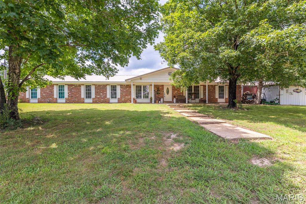 You've noticed and admired this home for years. Now is your chance to make it yours! This beautiful 4 bedroom, 3 bath brick home is less than 5 minutes from Doniphan. Cross the beautiful Current River on your way! The home sits on a surveyed 10 acre tract with plenty of mature trees and great deer hunting. It features an office that could convert into a 5th bedroom, above ground pool, garage/shop. This brick home with a metal roof will reduce your maintenance significantly. All electric with outdoor package unit for heat and air, plus a very efficient wood stove in the open dining/living area. There is very sufficient pantry and storage space for a large family. All 2500+ square feet of this home are on one level! The current owners (of 20+ years) have taken very good care of the home and are ready to relocate and downsize. If you are looking for a very nice home with no neighbors on top of you (but don't need 100 acres), look closely at this one.