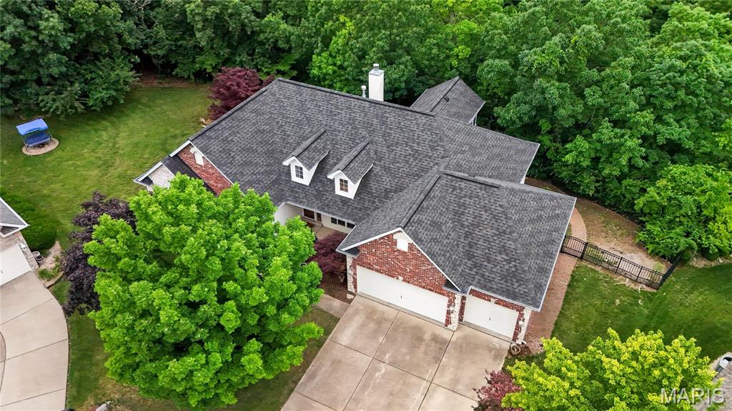 Pre-Holiday Open House, Thurs. 7/2 4:30 - 6:30pm and Sun 7/5, 1-3pm  Tucked away on a private .46-acre cul-de-sac lot backing to mature trees and Peruque Creek, this beautifully situated McKelvey Homes brick-and-stone ranch offers a rare blend of privacy, nature, and everyday comfort in the desirable Heather Glen subdivision. A total of a possible 4 Bedrooms and 3 Full Baths.  Enjoy peaceful wooded views, spectacular west-facing sunsets from the bluff, and outdoor living spaces designed to be enjoyed year-round, including a black iron fenced backyard with gates on both sides, tiered deck, paver patio, and lower-level patio.

Offering over 3,500 square feet of finished living space, plus a sunroom, finished lower level and plenty of storage remains, this home provides room to relax, gather, work, and entertain. The main level features impressive 10-foot ceilings, with even taller vaulted spaces that add to the open, airy feel. A welcoming foyer with hardwood floors, a decorative glass entry door, and dormer window sets the tone with natural light and warmth. Many rooms feature crown molding, and ceiling fans are found throughout the home for added comfort.

The vaulted great room is filled with sunlight from expansive windows and showcases wood flooring, recessed lighting, a beautiful two-sided gas fireplace, and soaring ceiling height. The spacious kitchen offers abundant cabinetry, a center island, plantation shutters, and an easy flow into the vaulted breakfast/hearth room, creating a comfortable gathering space for everyday living. Main-floor laundry includes wall cabinetry and a closet for added storage. The oversized three-car garage is fully drywalled and includes two openers. The roof was replaced in 2019 with architectural shingles at a cost of approximately $28,000.  HVAC system is Trane.

One of the home’s most special features is the sunroom, surrounded by windows and offering direct access to the deck. With its elevated setting and views of the trees, it creates a peaceful “perched in the trees” feeling and a beautiful place to enjoy the changing seasons. The landing and stairs have also been updated with composite planking.

The finished walkout lower level is enhanced by a deep-pour foundation, creating generous ceiling height and a spacious feel throughout. This level expands the home’s living and entertaining space with a large family room, recreation area, wet bar, office or possible sleeping area, full bath, and flexible space for guests, hobbies, media, or entertaining. With its scenic setting, spacious floor plan, quality construction, and inviting indoor-outdoor lifestyle, this home offers a wonderful value.

Home is in very good condition and believes to be move-in ready.  Fresh paint, carpeting and luxury vinyl tile installed. Seller resides out of state and is selling the home and irrigation system “as is” for seller’s convenience.