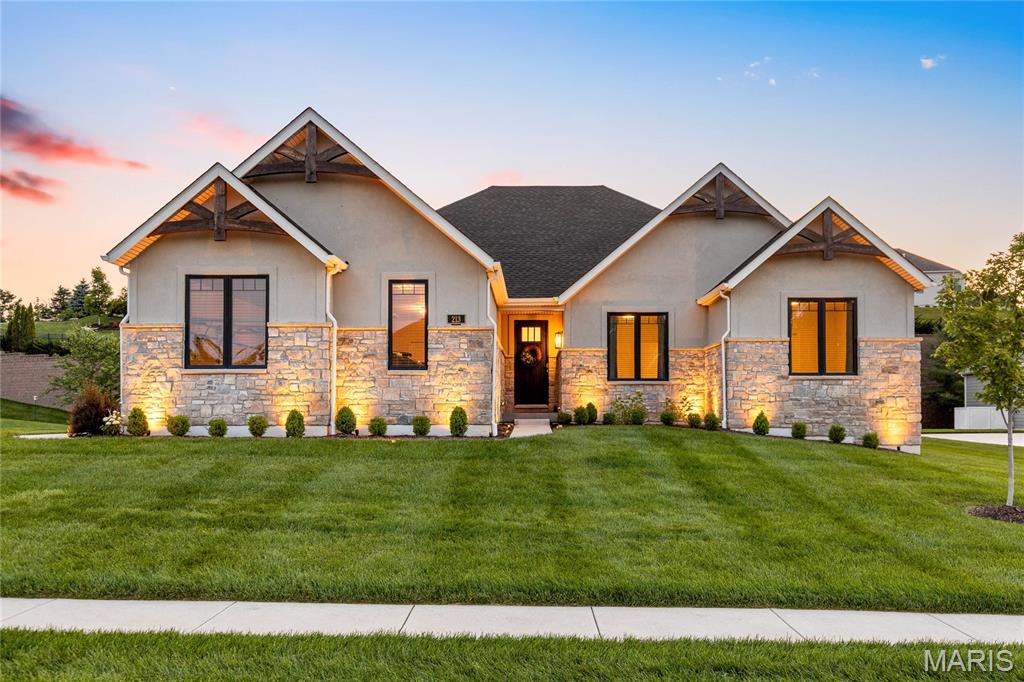 Sophisticated interior detailing & stylish appointments are featured throughout this exceptional Lombardo-built great room ranch in prestigious Westleigh—an exceptional value rarely found in this sought-after community. A welcoming porch entrance with an 8’ front door with glass panes leads to an impressive foyer, private study with double atrium doors, gracious dining room, and stunning great room with floor-to-ceiling stone fireplace and full-height windows that provide an abundance of natural light. The chef’s kitchen with 42” white Shaker cabinetry, quartz countertops, premium stainless steel appliances, and a 7’ center island offers an ideal space for both everyday living and entertaining. Off the main living area, the primary bedroom suite with tray ceiling, two walk-in closets, and luxury bath with freestanding tub provides a relaxing retreat. Two generously sized additional bedrooms and a hall full bath complete the main floor living quarters. Built with a desirable 9' foundation pour, the home offers enhanced lower-level potential and a spacious feel throughout. Situated on a professionally landscaped cul-de-sac lot within a wooded neighborhood and served by award-winning Wentzville schools.