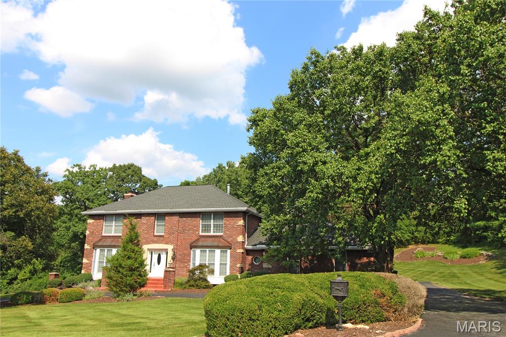 Gorgeous custom built all brick home with so much space!  Original owners!  Two wet bars! Five bedrooms with possible extra bedroom.  Basement has mother-in-law quarters with kitchenette.  Over an acre lot!  Huge eat-in kitchen with center island.  Huge master bath with whirlpool, double sinks and full shower!  Three woodburning fireplaces!  Large private yard!  Huge deck with patio beneath it!  Wooden doors!  Kitchen desk area!  Large marble entryway. Crown molding throughout! Walk out basement!  Sprinkler system!  Great location!  This is a must see!