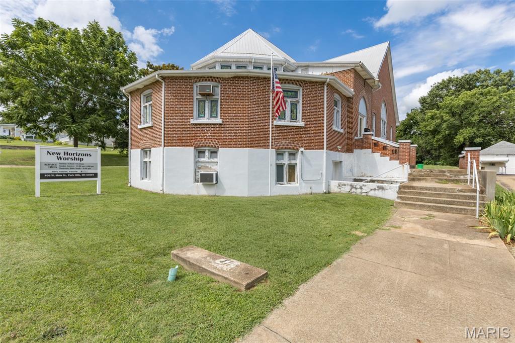 Welcome to this beautiful full-brick 3,224 sq. ft. church located in the heart of downtown Park Hills, Missouri. Rich in character and timeless craftsmanship, this stunning property is currently used as a place of worship and features breathtaking stained glass windows, soaring cathedral ceilings, and elegant church pews that create a truly inspiring atmosphere. The main level offers a spacious sanctuary with an open stage, baptism pool, pastor's office, director's office, Sunday school room, storage room, and restrooms. The finished lower level provides exceptional flexibility with a large recreation/meeting area, full kitchen, additional restrooms, and ample space for fellowship or community events. Plenty of parking is available in the rear of the building. Whether you're seeking a place of worship, community center, event venue, or another special-purpose property, this well-maintained building offers endless possibilities in a prime downtown location.