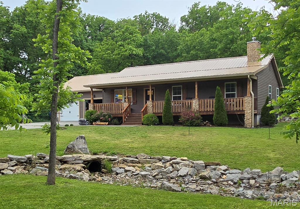 Charming country home on 2 unrestricted acres. No HOA. 6 years old. Completely move in ready. 4 minutes from the Katy trail. 4 minutes from Defiance Ridge Vineyards and a short drive to many other venues. This private and peaceful property features hardwood floors, large porches in the front and rear with ceiling fans. New granite countertops, with farmhouse sink, beautiful backsplash and under cabinet lighting. First floor laundry off master bedroom. Partially finished lower level with a full bath (with steam shower), full kitchen, wood burning stove. Over sized attached 2 car garage and a large oversized 2 car separate garage/storage/work shop. Relax on the front and rear porches surrounded by peaceful woods or explore all Defiance has to offer. 3 minutes to DD market, 12 minutes to Lake Saint Louis (wal-mart, lowes, aldi, dierbergs, restaurants, etc). This is an unbelievable location. 831 Old Colony road, Defiance mo 63341. It is the first house on the right after you turn off of Double D. Very low traffic volume on Old Colony.