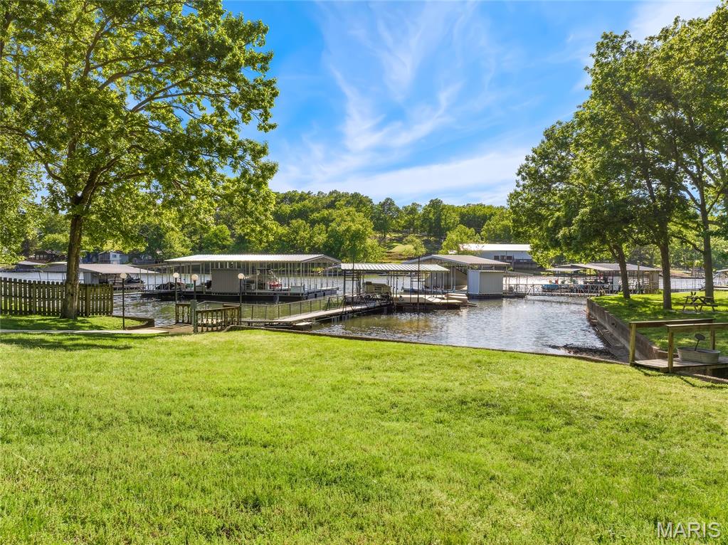 EXTREMELY MOTIVATED SELLER. This large lakefront home with nearly flat lakefront yard, acreage, substantial garage/shop space, and no HOA or restrictions. With approx. 5,415 sqft, 5 beds, 4 baths, 3.39 acres, approx. 100 ft of lakefront, a large attached garage, and an approx. 2,326 sq ft detached shop, this property is well-suited for buyers needing room for vehicles, lake toys, equipment, business use, hobbies, guests, or multi-purpose living. The home offers open main-level living leading to a new composite deck. There's also a nearly 600sqft room perfect for gym or bunk room. The massive upper primary wing includes dual vanities, tile shower, walk-in closets, and private HVAC. A separate upper level features two additional bed/bunk rooms with walk-in closets. Even more living space in walk-out with a bed, a bath, a storm/safe room, and a rough-in for a future wet bar. An impressive & efficient masterpiece with extensive insulation, 400amp underground, 5 HVAC systems, private well, Gravois sewer, newer mechanicals, dock, and quick access to lakefront destinations make this a highly livable and VRBO-able, Lake of the Ozarks property. Check out the feature sheet to see all that this property has to offer.